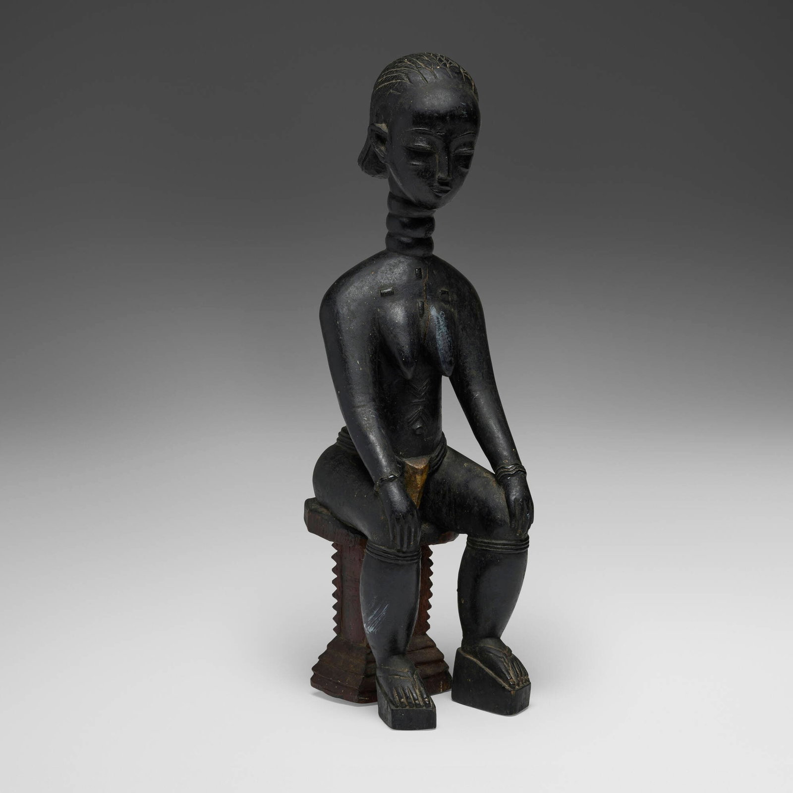 Mende, Seated female figure: Mende Seated female figure Sierra Leone, 20th century carved wood 18 h x 5 w x 6.5 d in (46 x 13 x 17 cm) Provenance: Private Collection, Maryland This work will ship from Chicago, Illinois.