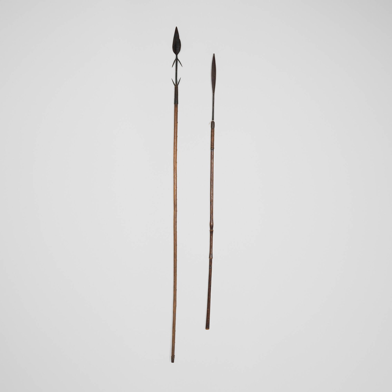Tonga, Spears, set of two: Tonga Spears, set of two Zimbabwe, early 20th century carved wood, iron, copper 60 h x 1 dia in (152 x 3 cm) 73 h x 2.5 dia in (185 x 6 cm) A similar two-barbed example can be seen in this <