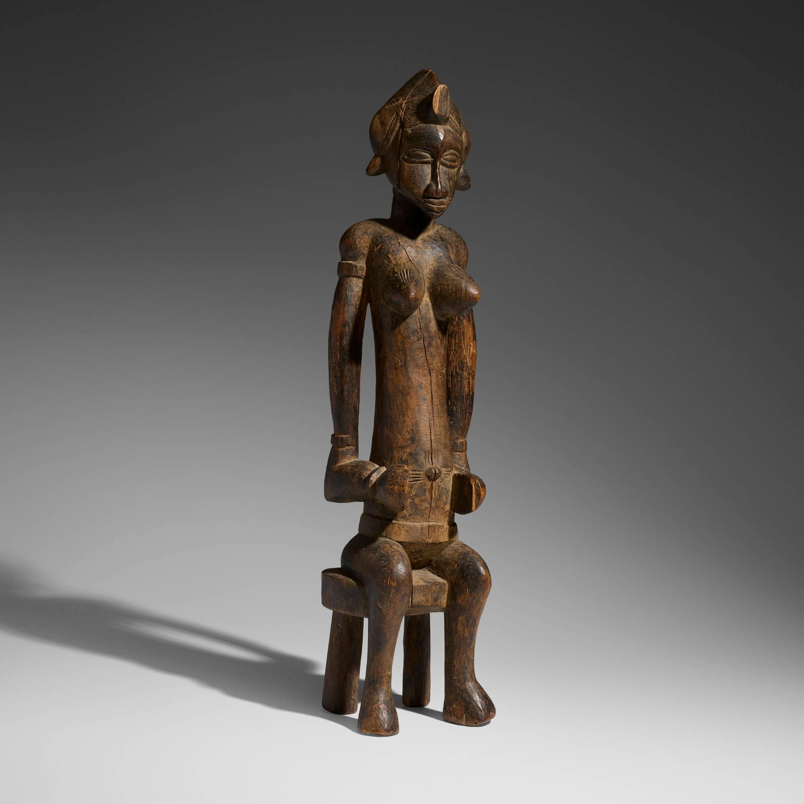 Senufo, Seated female figure: Senufo Seated female figure Cote d'Ivoire, 20th century carved wood 30 h x 7.5 w x 7 d in (76 x 19 x 18 cm) This work will ship from Chicago, Illinois.