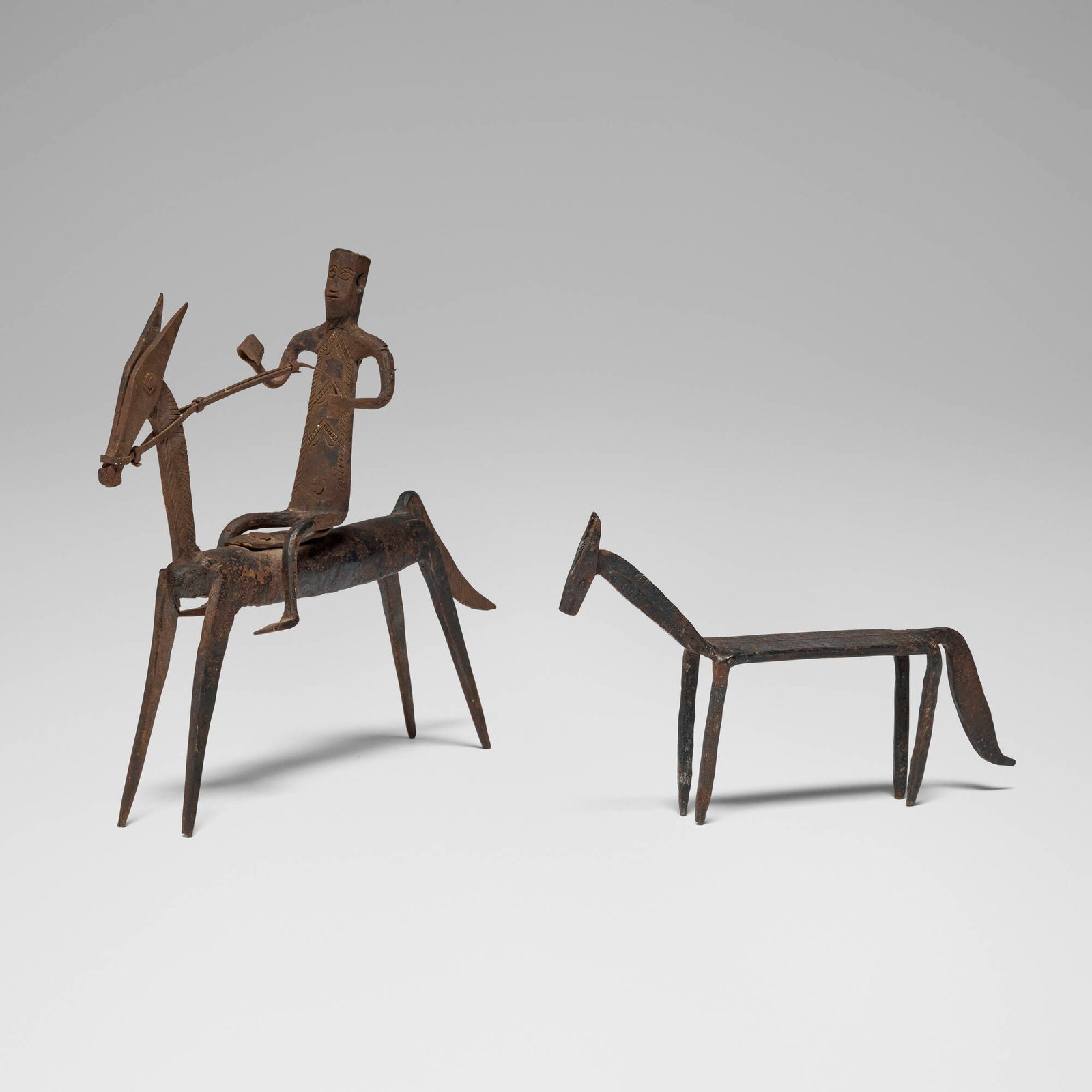 Dogon, Equestrian figure and horse: Dogon Equestrian figure and horse Mali, 20th century iron 9.75 h x 2.75 w x 12.5 d in (25 x 7 x 32 cm) 5.5 h x 1.25 w x 8.75 d in (14 x 3 x 22 cm) This work will ship from Los Angeles, California.