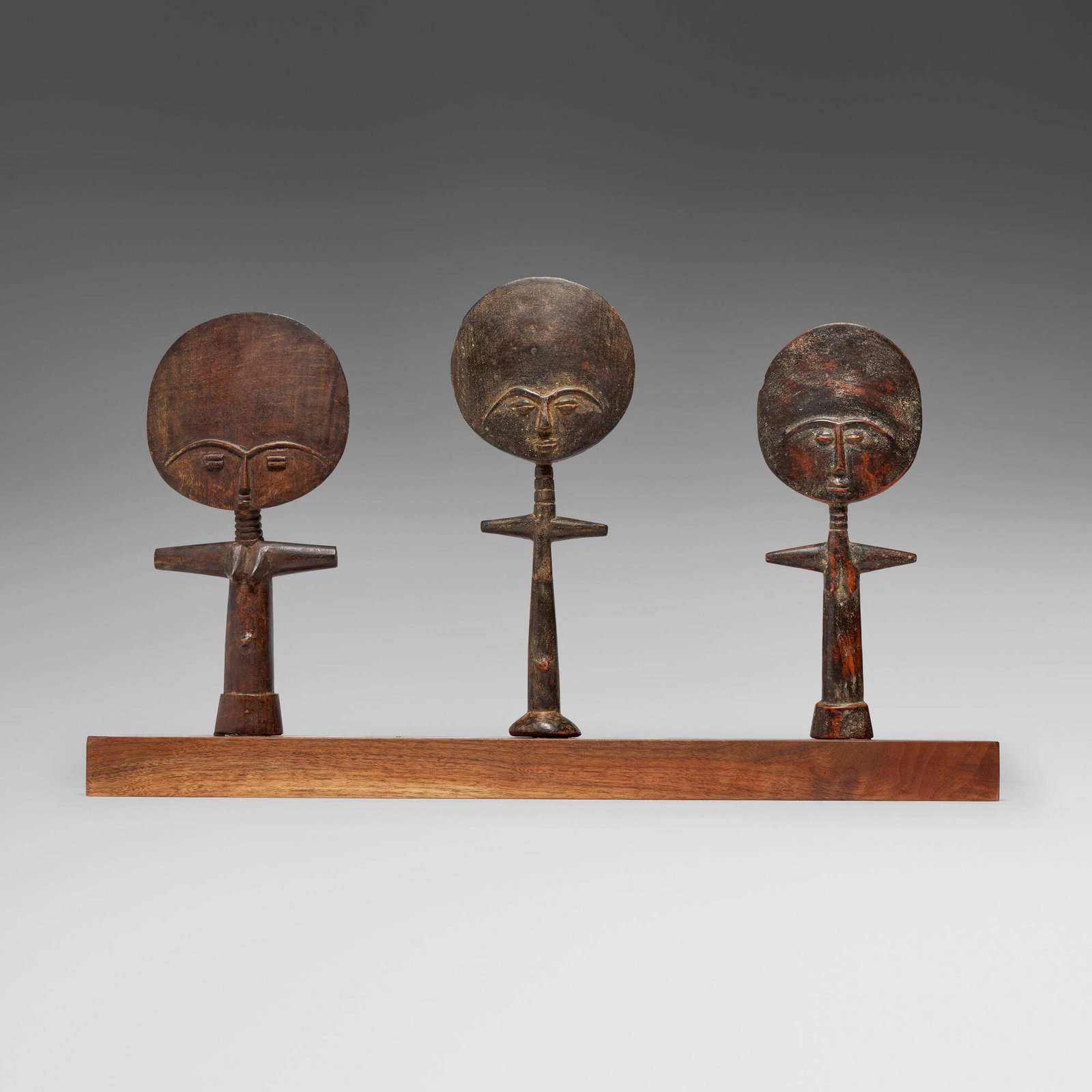 Asante (Ashanti), Akua'ba fertility figures with custom base: Asante (Ashanti) Akua'ba fertility figures with custom base Ghana, 20th century carved wood 16 h x 6.25 w x 2.5 d in (41 x 16 x 6 cm) 14.75 h x 7 w x 2.5 d in (37 x 18 x 6 cm) 14.25 h x 5.75 w x 1.5
