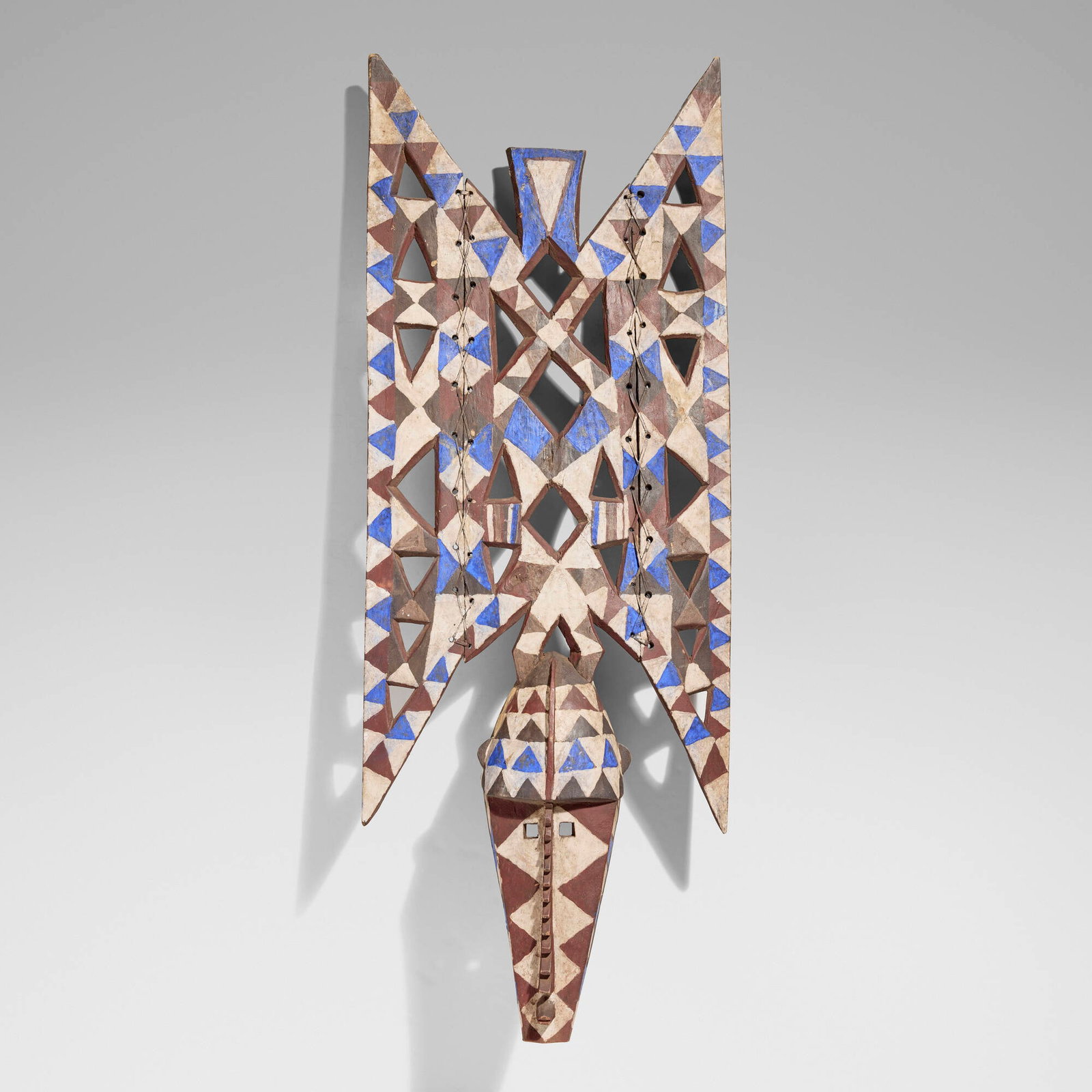 Bwa, Plank mask: Bwa Plank mask Burkina Faso, 20th century carved wood, pigment, leather 57 h x 21 w x 10 d in (145 x 53 x 25 cm) Provenance: The Sam and Beverly Maloof Collection This work will ship from Los