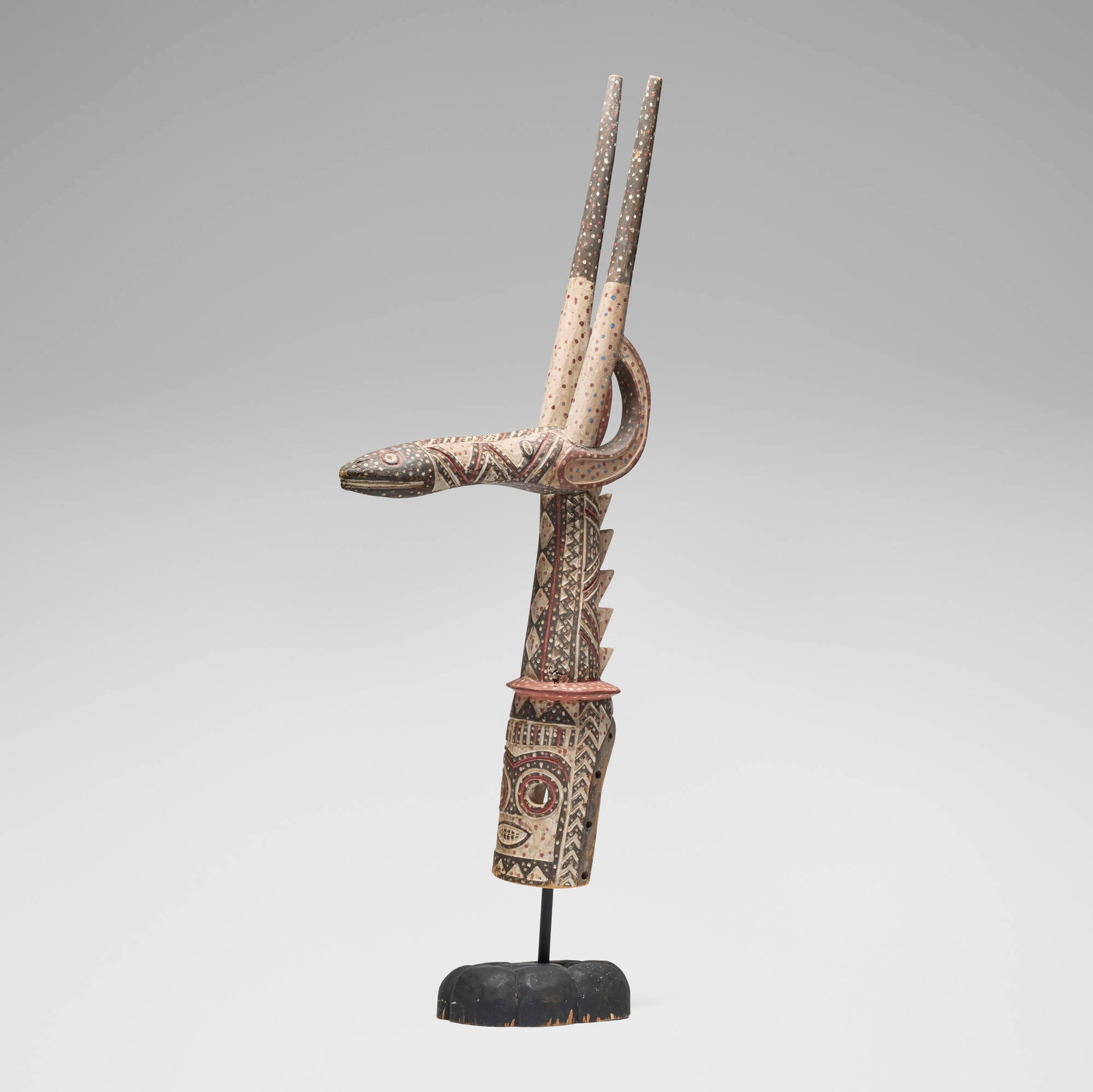 Kurumba, Adone (antelope) headdress: Kurumba Adone (antelope) headdress Burkina Faso, 20th century carved wood, pigment 56.5 h x 8.5 w x 24 d in (144 x 22 x 61 cm) Provenance: The Sam and Beverly Maloof Collection This work will ship