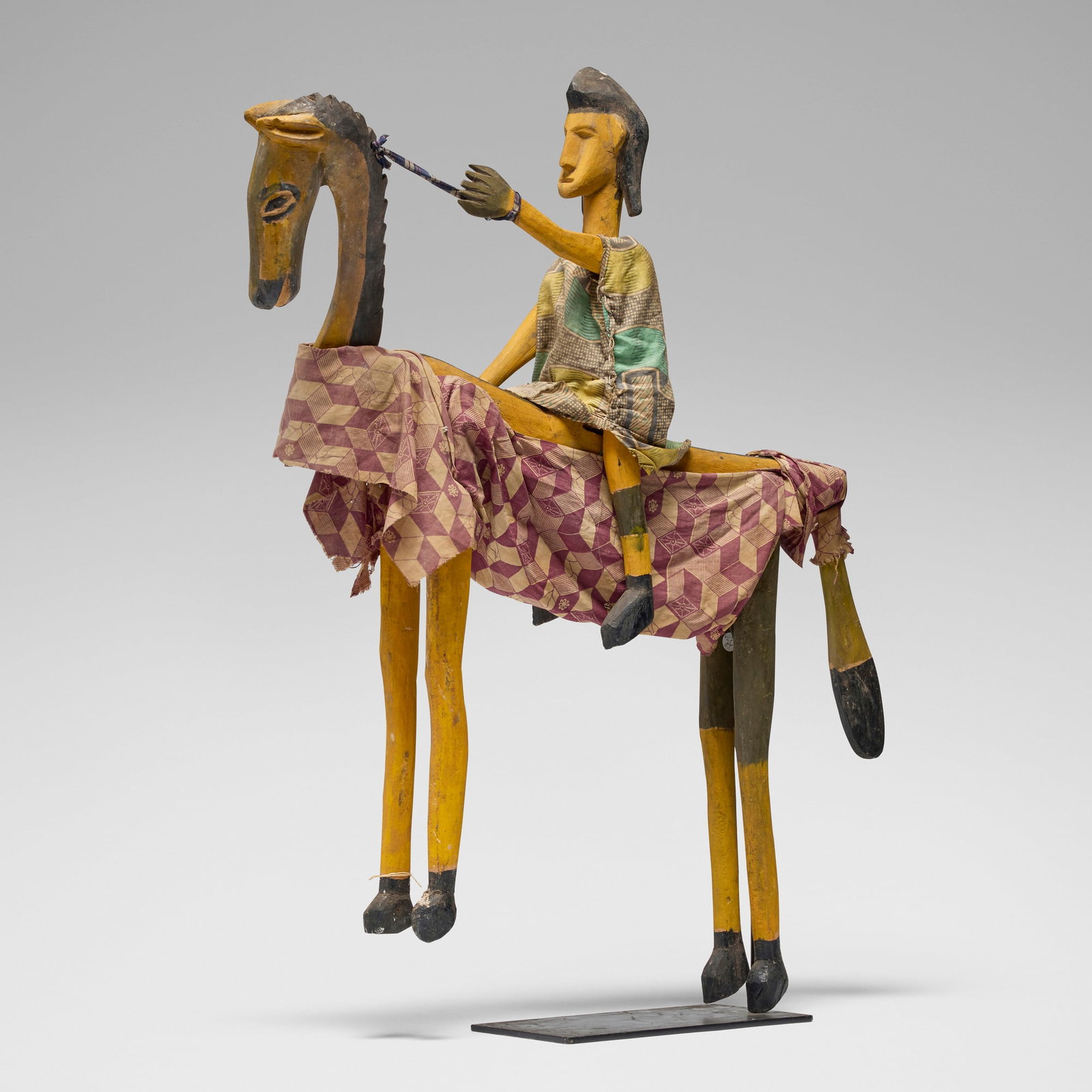Bamana, Horse and rider marionette: Bamana Horse and rider marionette Mali, 20th century carved wood, pigment, textile 36 h x 6 w x 31 d in (91 x 15 x 79 cm) Provenance: The Sam and Beverly Maloof Collection This work will ship from