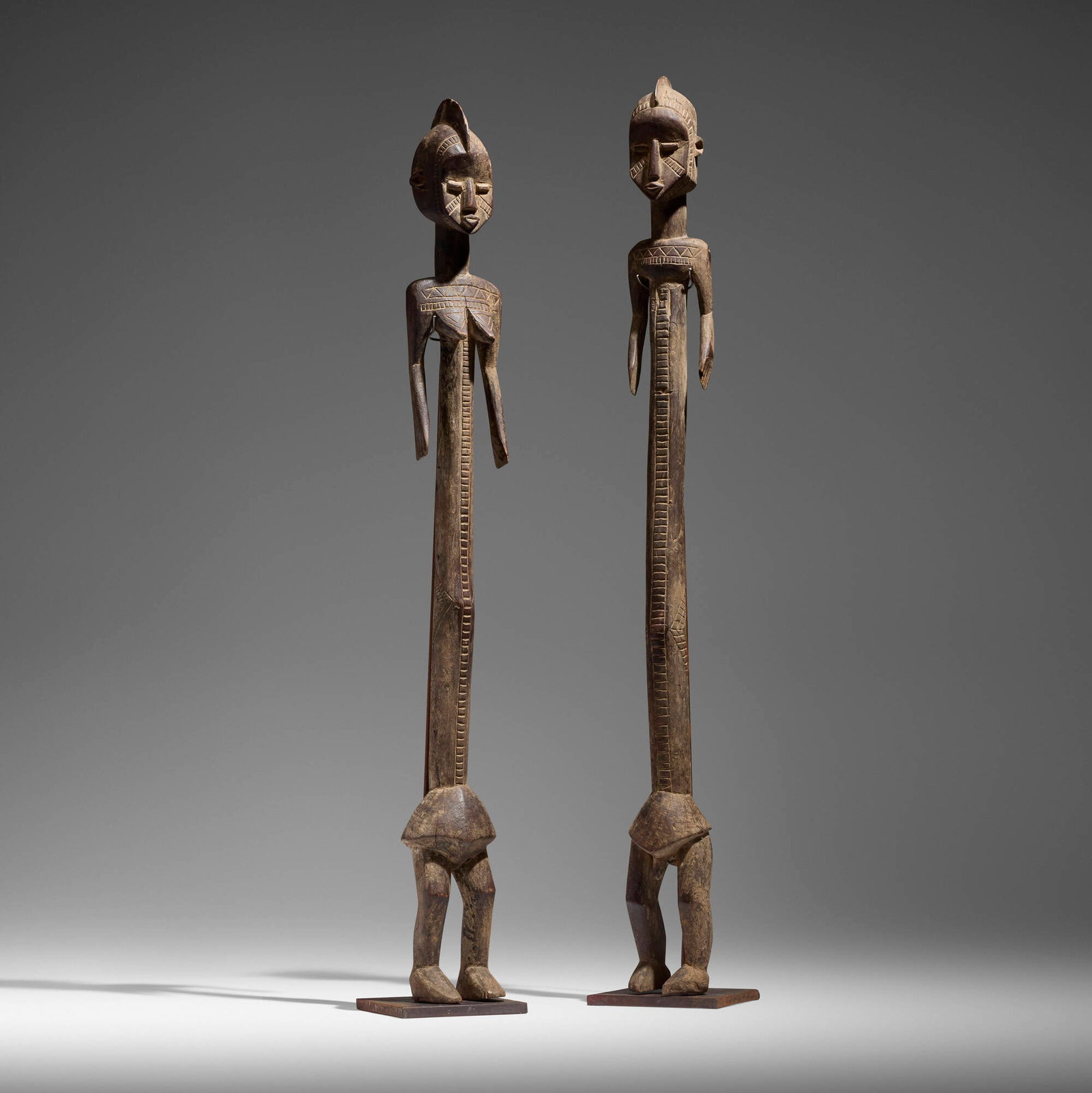 Mossi, Male and female figures, pair: Mossi Male and female figures, pair Burkina Faso, 20th century carved wood, pigment 43.5 h x 4.25 w x 4 d in (110 x 11 x 10 cm) 42 h x 4.25 w x 4 d in (107 x 11 x 10 cm) Provenance: The Sam and