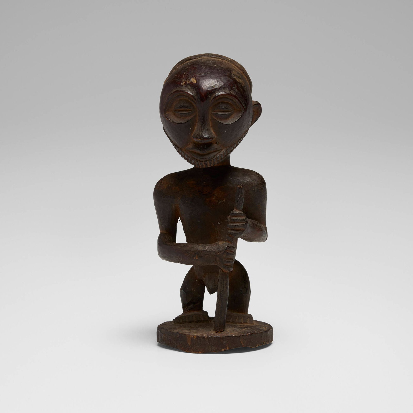 Hemba, Male statuette: Hemba Male statuette Democratic Republic of the Congo, 20th century carved wood 5.5 h x 2.5 w x 2.25 d in (14 x 6 x 6 cm) The present lot is a secular statuette of a male elder.