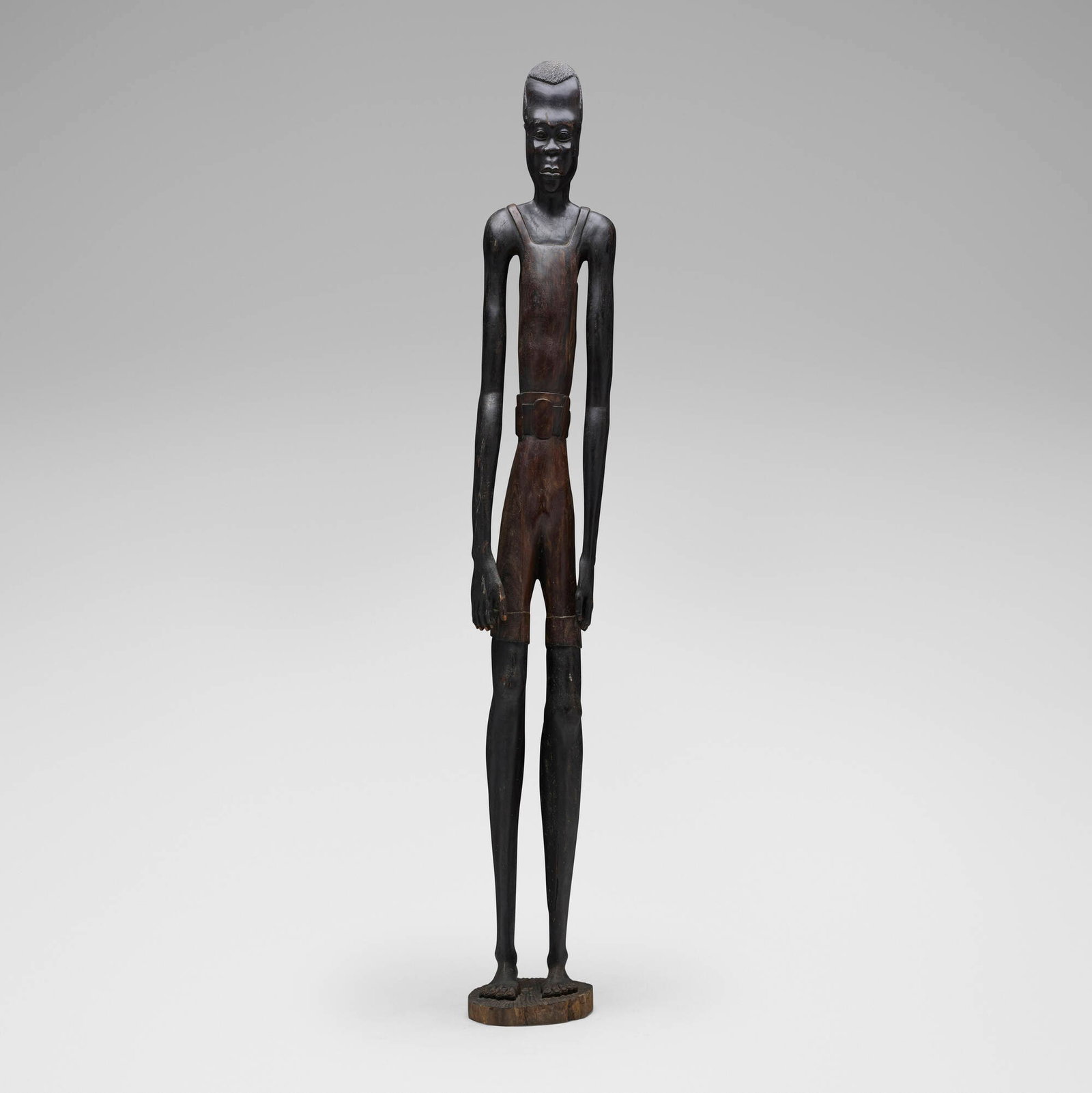 Likely Makonde, Colon figure: Likely Makonde Colon figure Tanzania, 20th century carved ebony 71.75 h x 11 w x 7 d in (182 x 28 x 18 cm) Carved signature to base 'J. Mense'. The present lot is a dramatically elongated