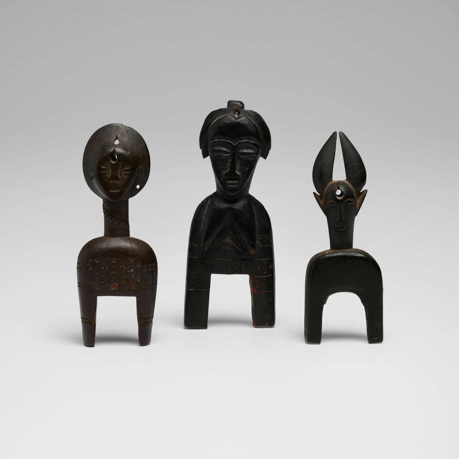 West African, Heddle pulleys, set of three: West African Heddle pulleys, set of three 20th century carved wood 5.5 h x 2 w x 1 d in (14 x 5 x 3 cm) 5.25 h x 1.75 w x 0.75 d in (13 x 4 x 2 cm) 5 h x 2 w x 0.75 d in (13 x 5 x 2 cm) Provenance: