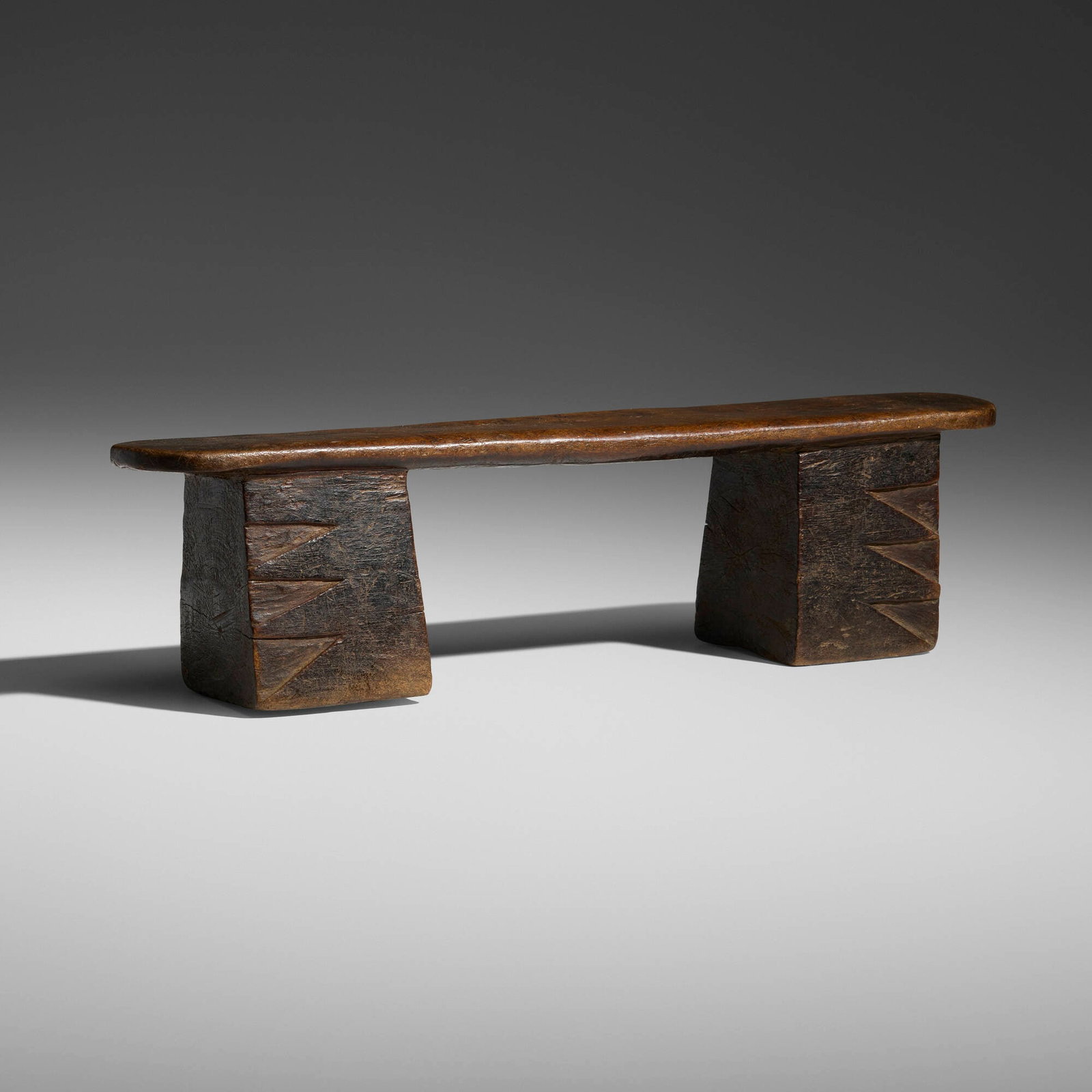 Zulu, Headrest: Zulu Headrest South Africa, 20th century carved wood 4.25 h x 16.5 w x 3.5 d in (11 x 42 x 9 cm) This two-legged Zulu headrest has a flat saddle rounded at the ends, the legs are fire-blackened with