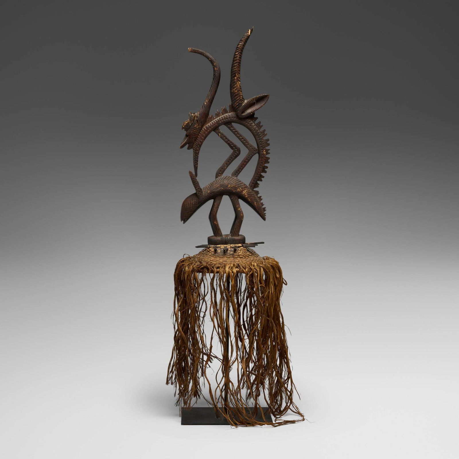 Bamana, Chi Wara (antelope headdress): Bamana Chi Wara (antelope headdress) Mali, 20th century carved wood, raffia, cord, wicker 35 h x 8 w x 8 d in (89 x 20 x 20 cm) This work will ship from Chicago, Illinois.