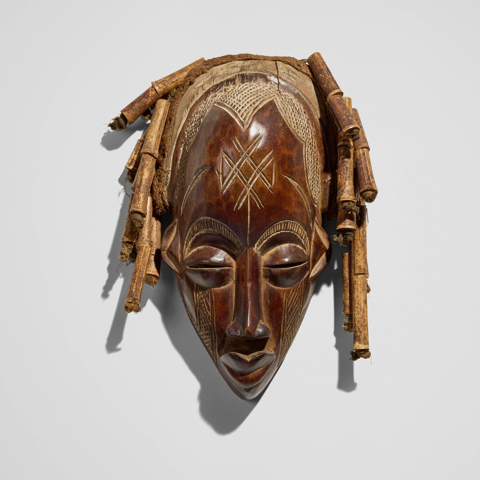 Chokwe, Mask: Chokwe Mask Angola, 20th century carved wood, bamboo, textile 15 h x 10 w x 7 d in (38 x 25 x 18 cm) Provenance: Private Collection, San Marino, CA This work will ship from Los Angeles, California.