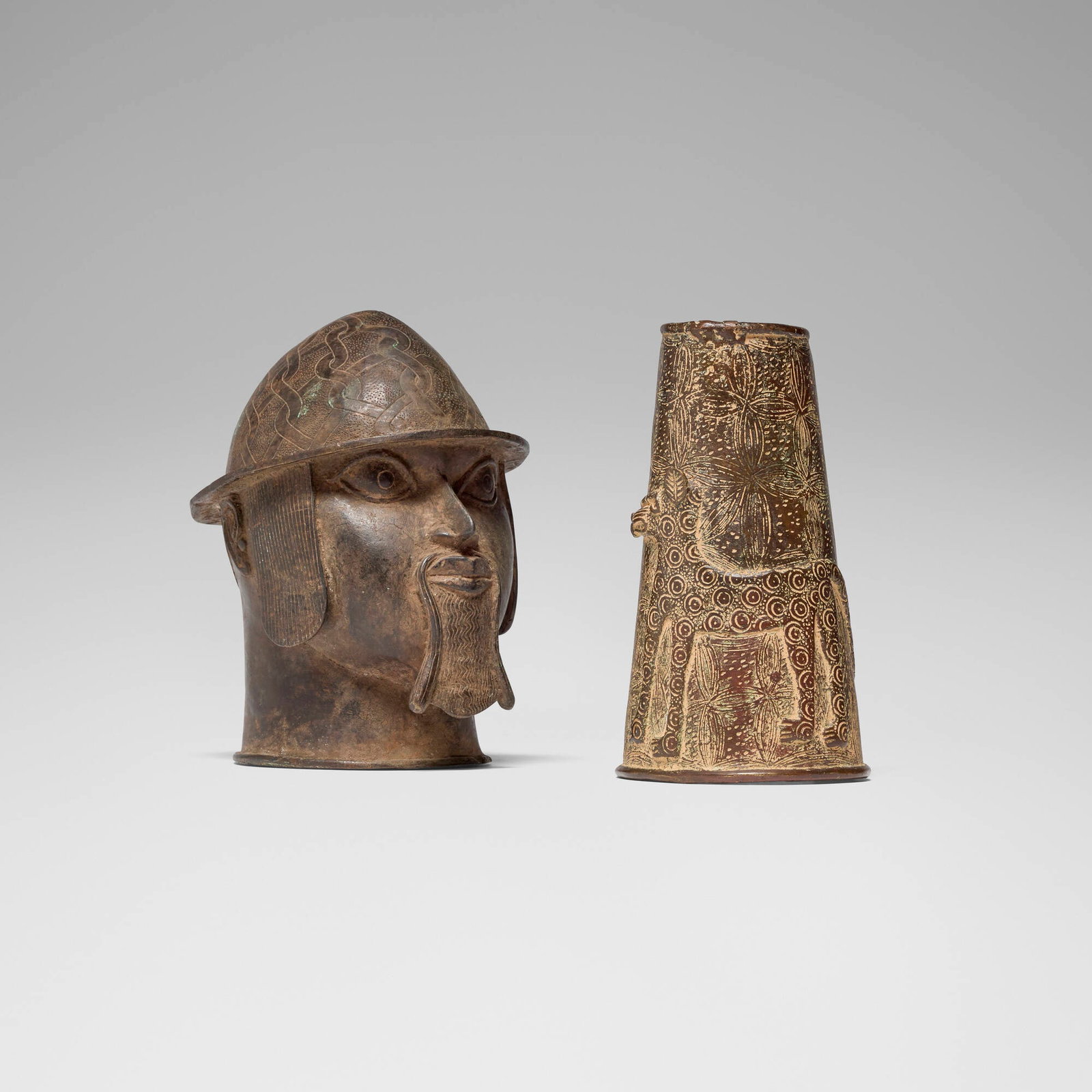 Benin, Head of a Portuguese soldier and cuff with leopard: Benin Head of a Portuguese soldier and cuff with leopard 20th century bronze 9 h x 6 w x 8 d in (23 x 15 x 20 cm) 8.75 h x 4.75 w x 4.25 d in (22 x 12 x 11 cm) This work will ship from Los Angeles,