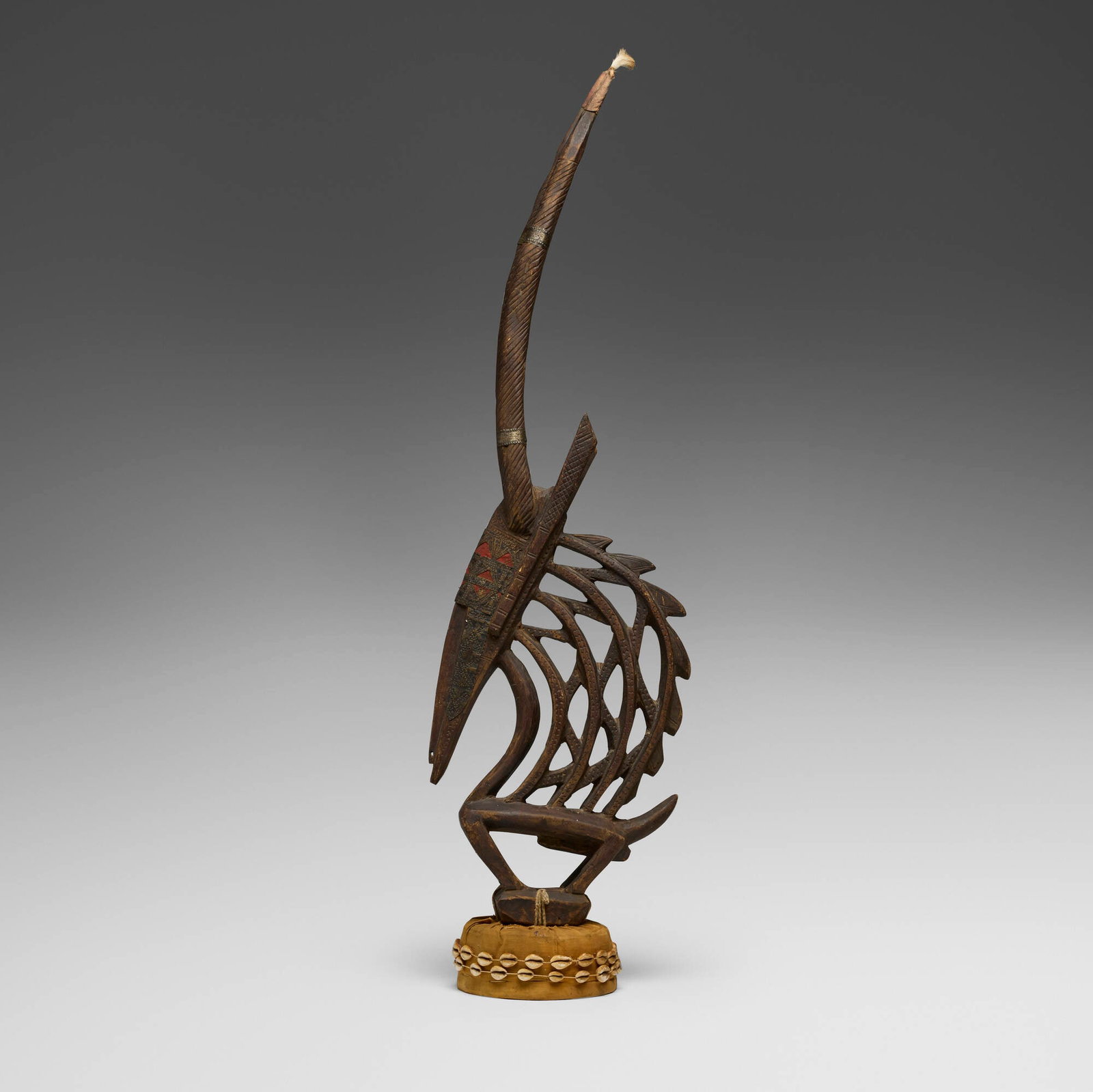 Bamana, Chi Wara (antelope headdress): Bamana Chi Wara (antelope headdress) Mali, 20th century carved wood, metal, cloth, cowry shells, rope, wicker 44 h x 12.5 w x 7 d in (112 x 32 x 18 cm) This work will ship from Chi