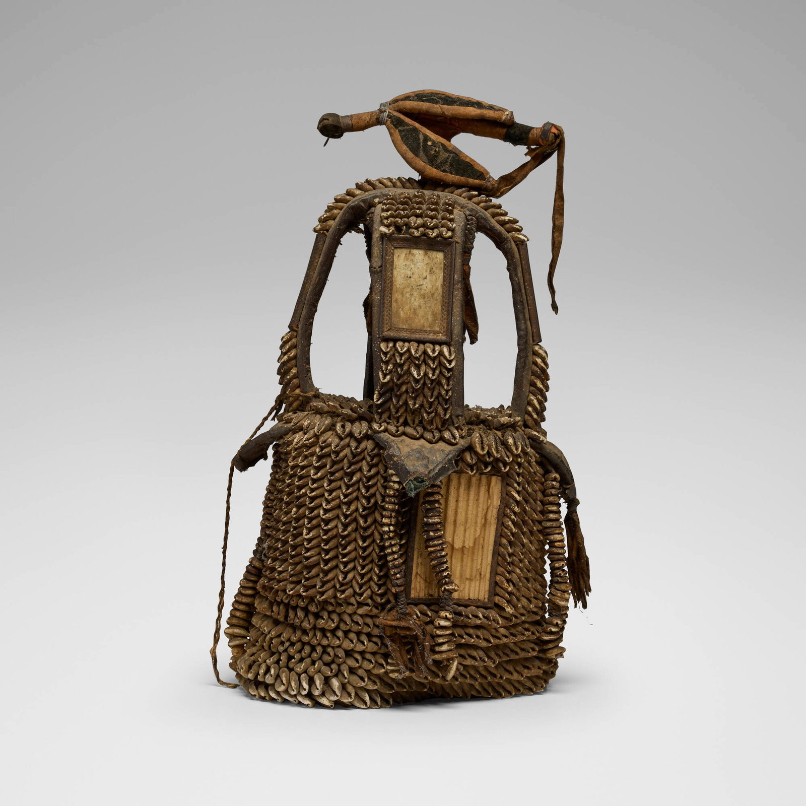 Yoruba, Ile Ori (House of the Head): Yoruba Ile Ori (House of the Head) Nigeria, 20th century cowry shells, leather, glass, metal, cloth 22 h x 11 dia in (56 x 28 cm) This work will ship from Chicago, Illinois.