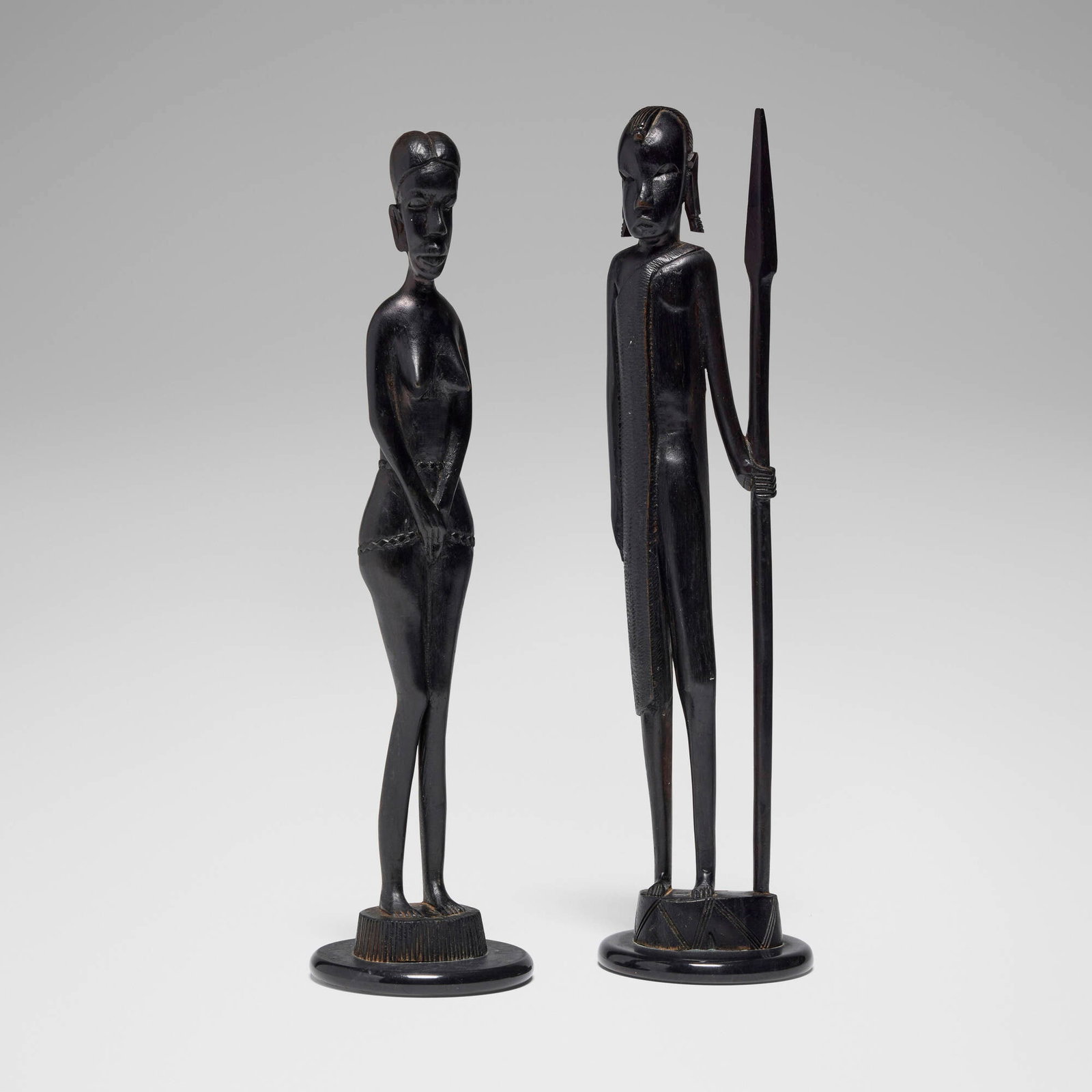 East African, Figures, set of two: East African Figures, set of two c. 1945 carved ebony 16 h x 4 dia in (41 x 10 cm) 15 h x 4 dia in (38 x 10 cm) This work will ship from Los Angeles, California.