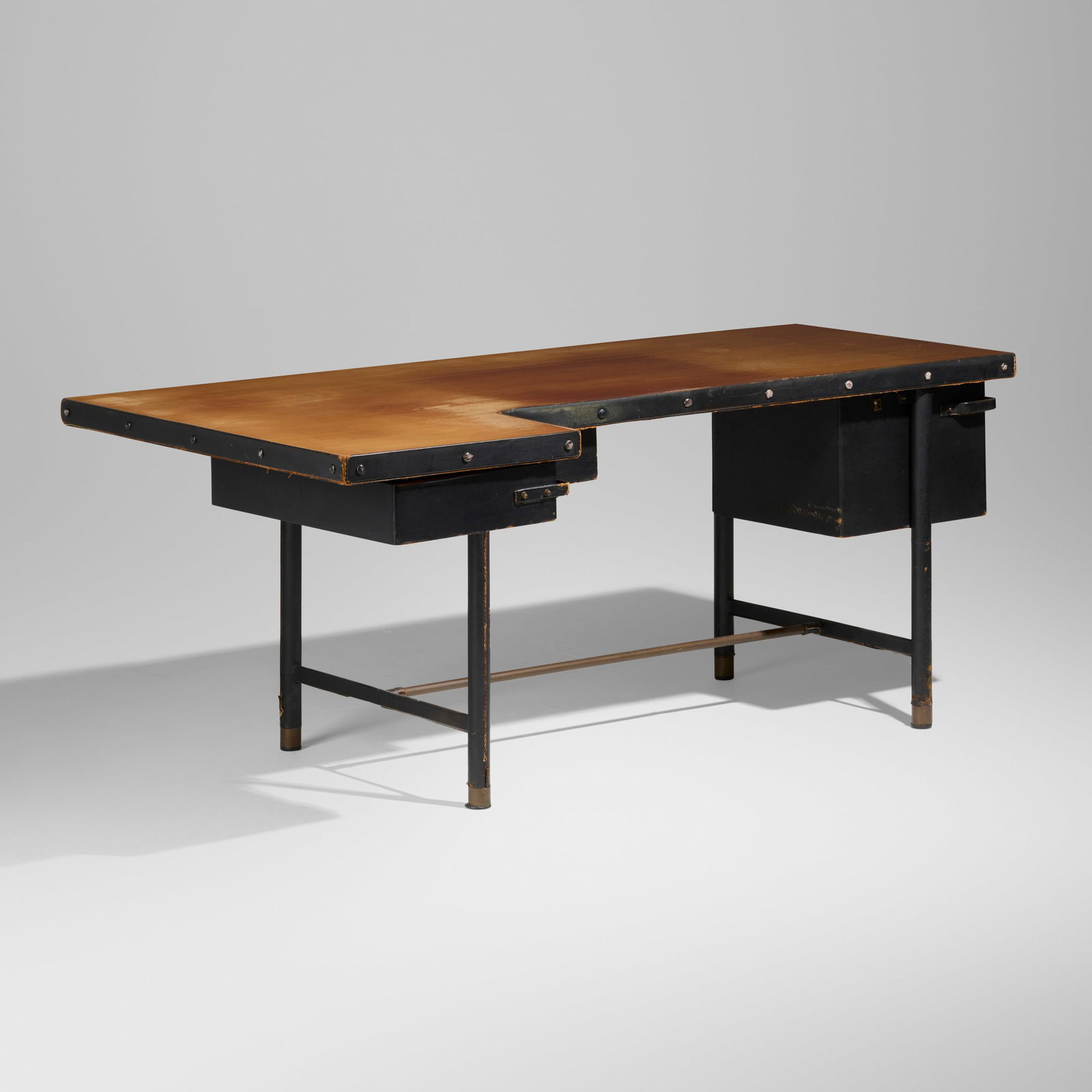Jacques Quinet, Executive desk: Jacques Quinet Executive desk France, c. 1950 beech, saddle-stitched leather over steel, brass 29.75 h x 71.5 w x 38.75 d in (76 x 182 x 98 cm) Desk features two swivel drawers concealing three
