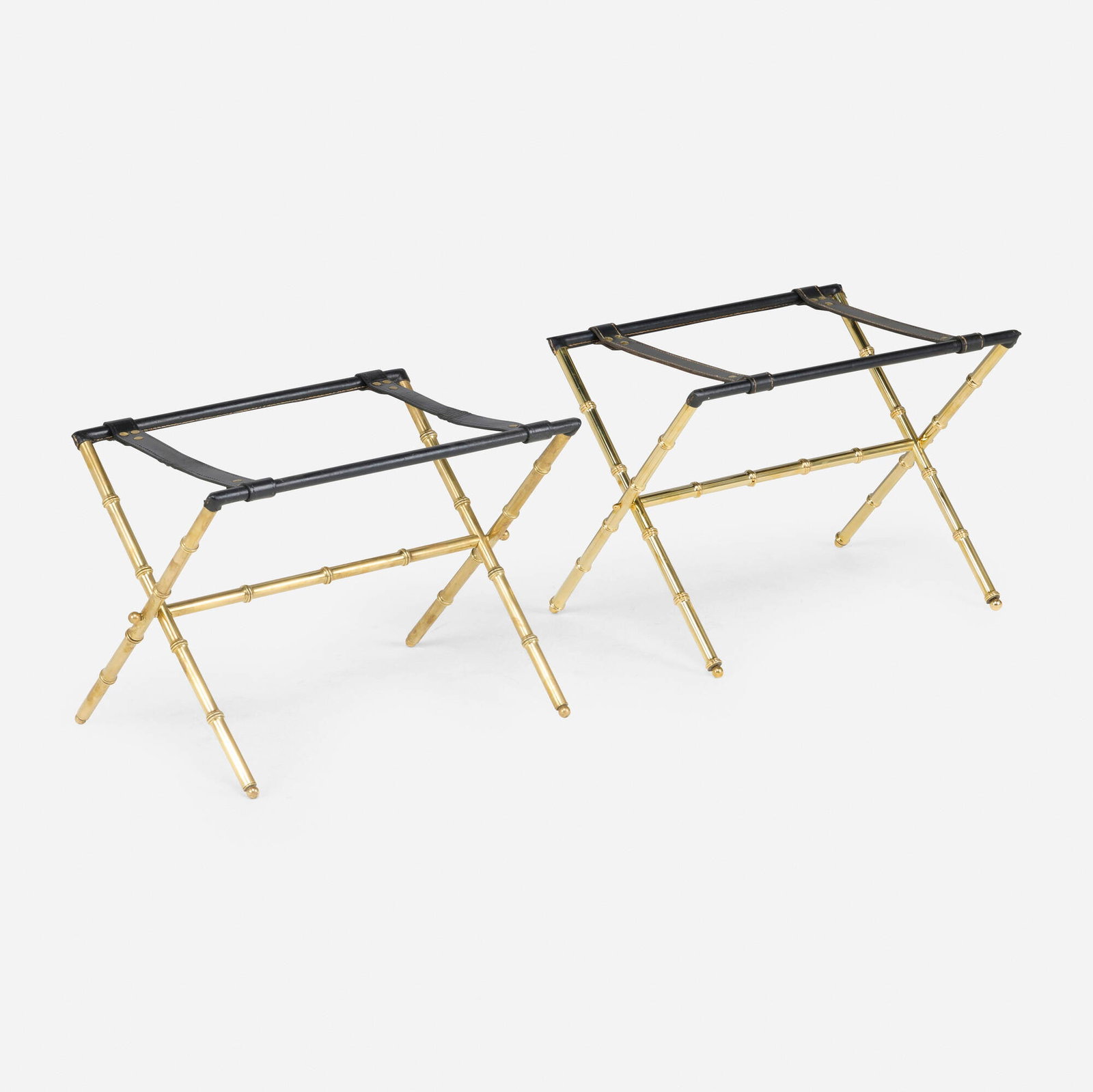 Jacques Adnet, Luggage stands, pair: Jacques Adnet Luggage stands, pair France, c. 1950 brass-plated steel, saddle-stitched leather 17.5 h x 24 w x 16.5 d in (44 x 61 x 42 cm) Literature: Jacques Adnet, Hardy and Millet, pg. 227 This