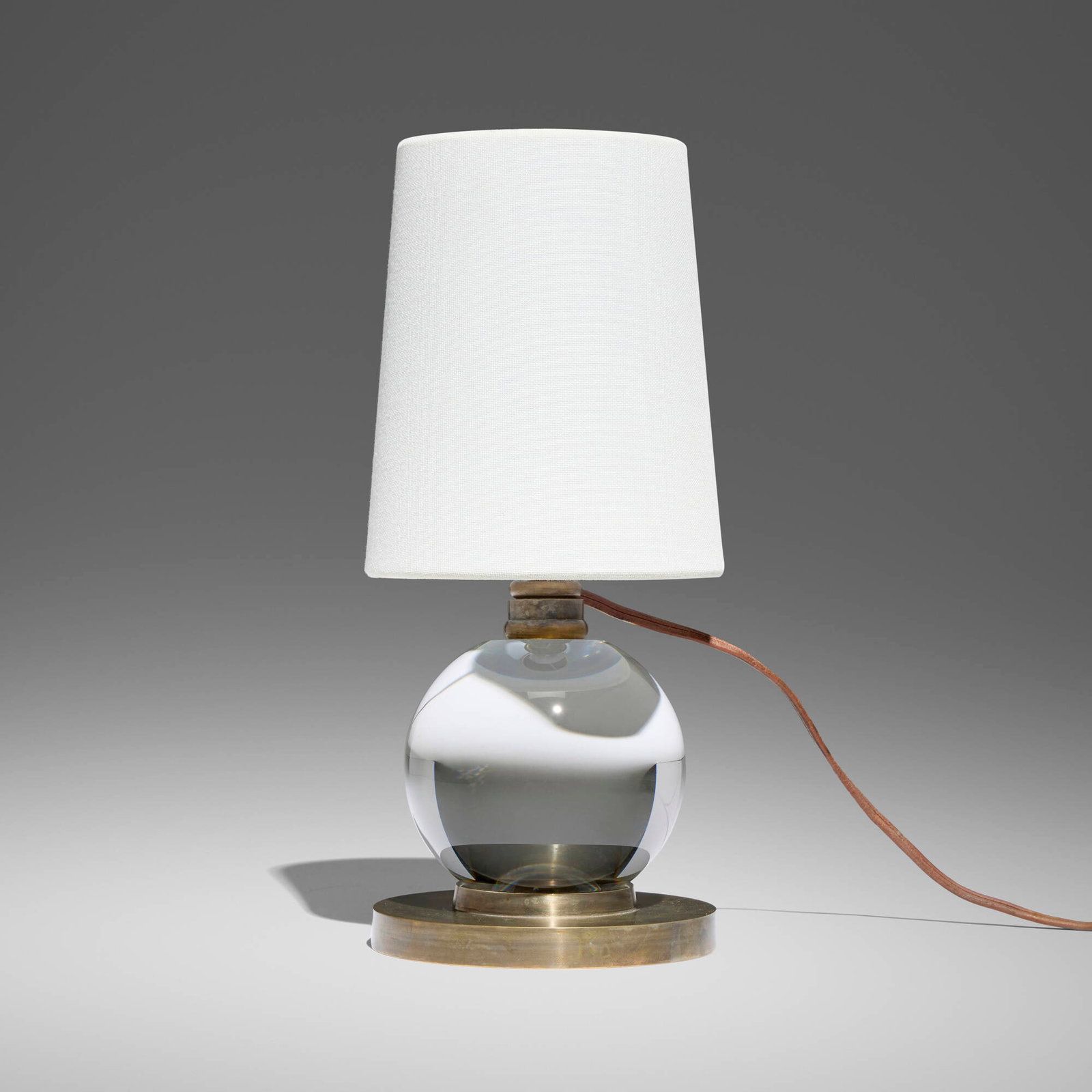 Jacques Adnet, attribution, Table lamp: Jacques Adnet, attribution Table lamp France, c. 1930 crystal, brass, fabric 11 h x 5 dia in (28 x 13 cm) This work will ship from Los Angeles, California.