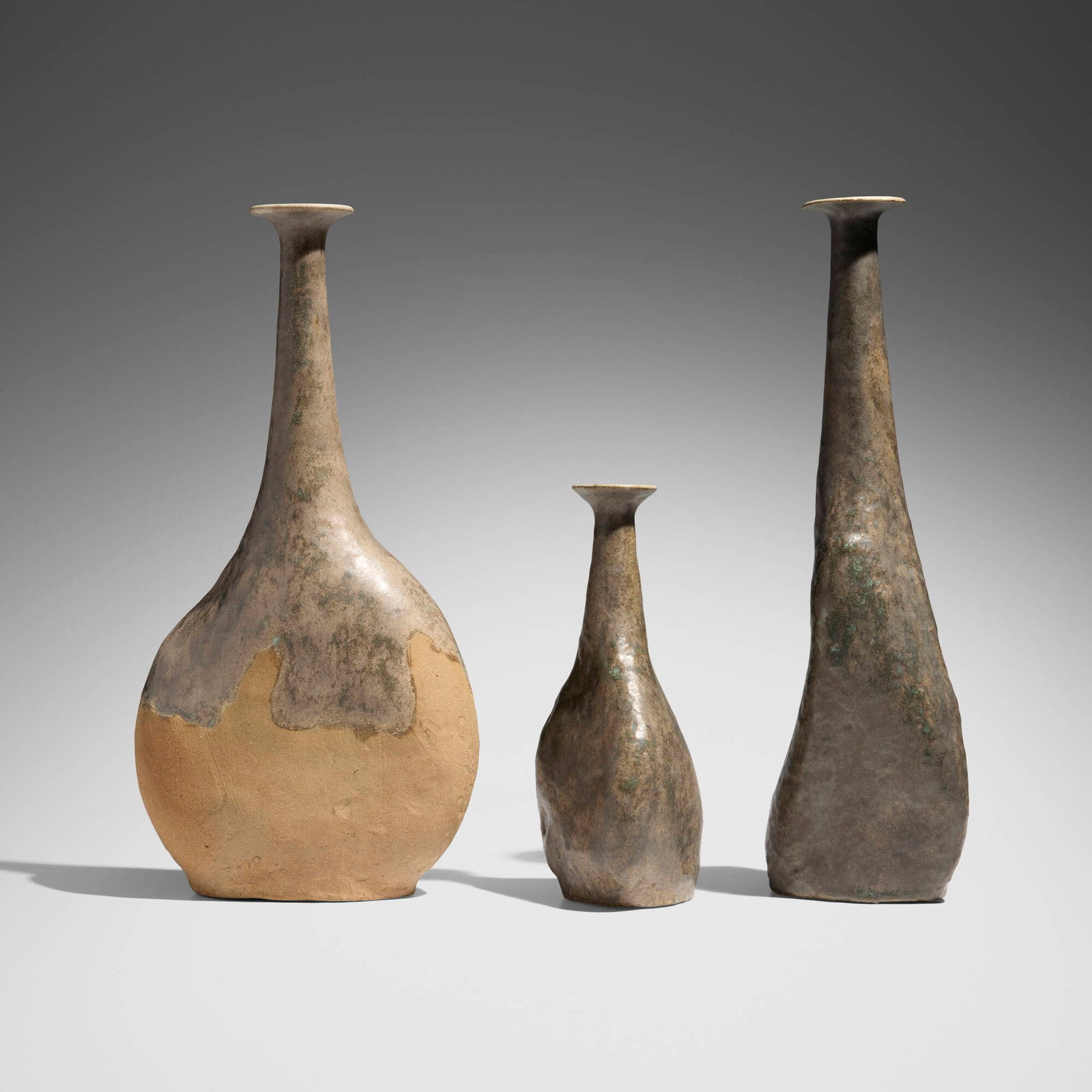 Bruno Gambone, Collection of three vases: Bruno Gambone Collection of three vases glazed stoneware 16.125 h x 5.25 w x 3.5 d in (41 x 13 x 9 cm) 15.875 h x 8 w x 4.125 d in (40 x 20 x 10 cm) 9.5 h x 4.5 w x 4 d in (24 x 11 x 10 cm) Gl
