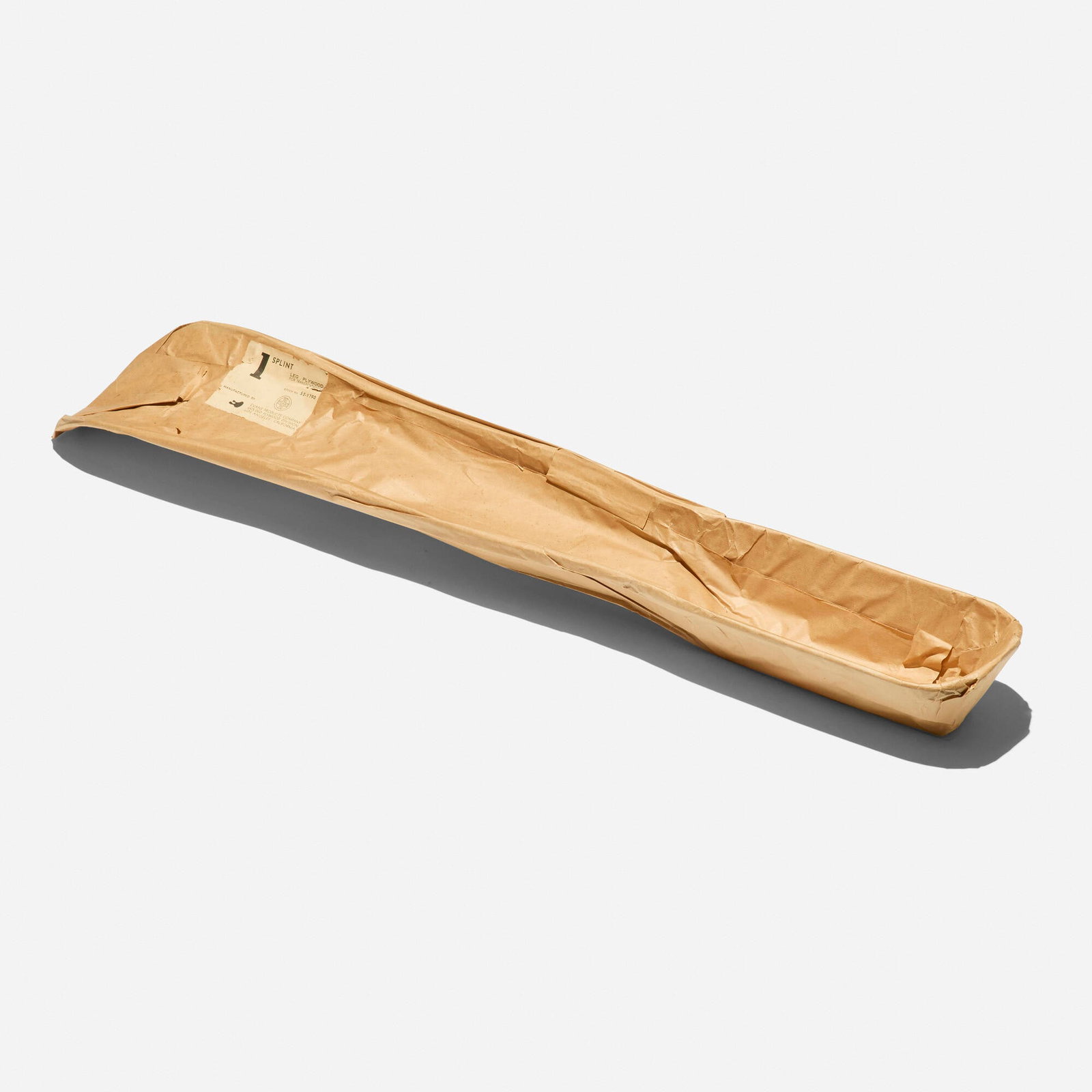 Charles and Ray Eames, Leg splint in original packaging, model S2-1790: Charles and Ray Eames Leg splint in original packaging, model S2-1790 Evans Products USA, 1943 Douglas fir plywood 42 h x 7.75 w x 4 d in (107 x 20 x 10 cm) Paper manufacturer's label to