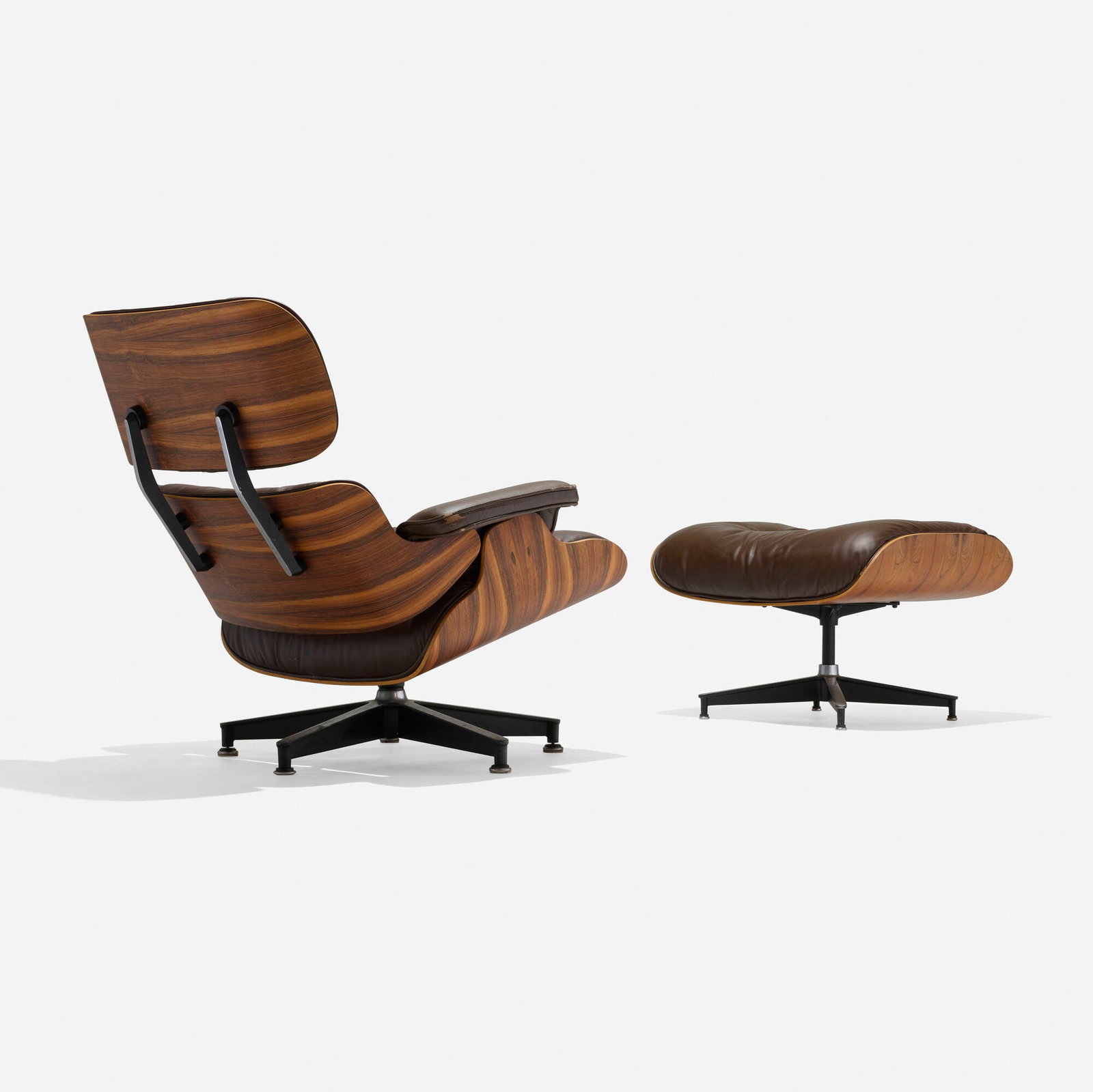 Charles and Ray Eames, 670 lounge chair and 671 ottoman: Charles and Ray Eames 670 lounge chair and 671 ottoman Herman Miller USA, 1956 / c. 1980 rosewood plywood, leather upholstery, enameled brushed aluminum, rubber chair: 32.25 h x 33 w x 36.5 d in (82