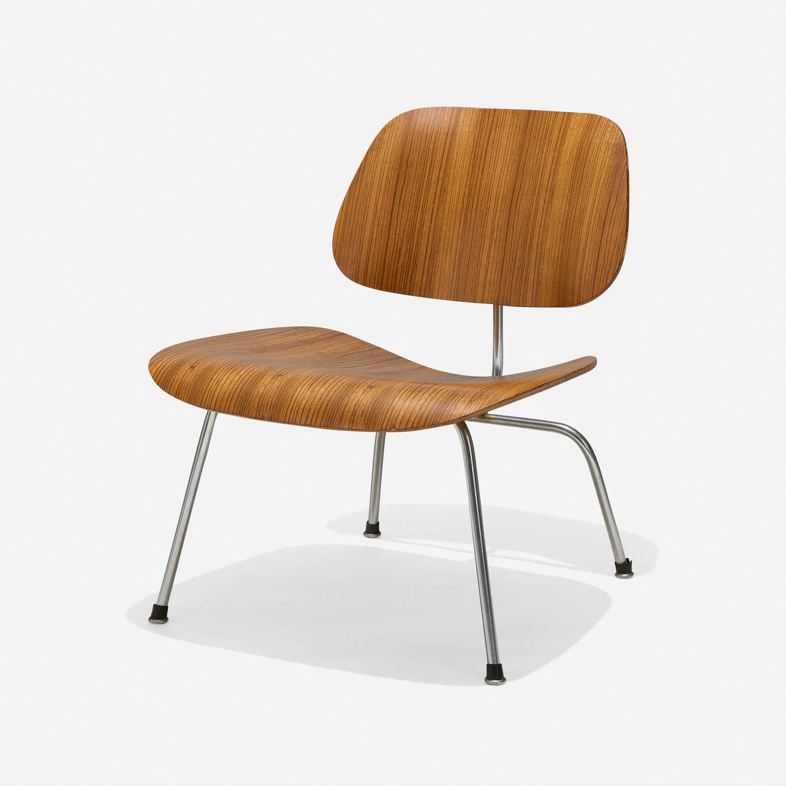 Charles and Ray Eames, LCM: Charles and Ray Eames LCM Herman Miller USA, 1946 / c. 1958 calico ash plywood, chrome-plated steel, rubber 26.25 h x 22.25 w x 25 d in (67 x 57 x 63 cm) Provenance: Collection of Normand Mainville