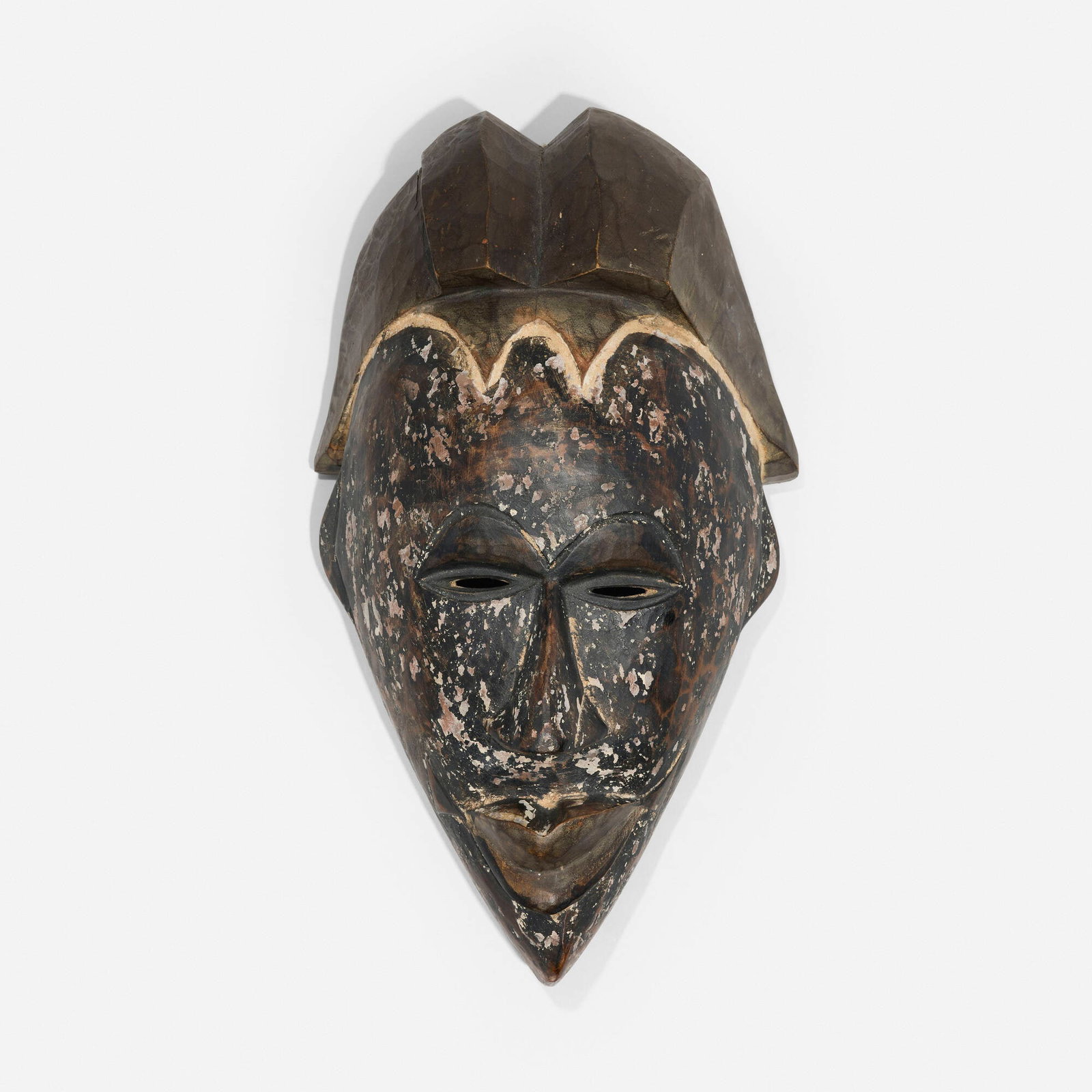 Igbo, Mask: Igbo Mask Nigeria, 20th century carved wood 18 h x 9.5 w x 6 d in (46 x 24 x 15 cm) Provenance: Collection of Normand Mainville This work will ship from Chicago, Illinois.