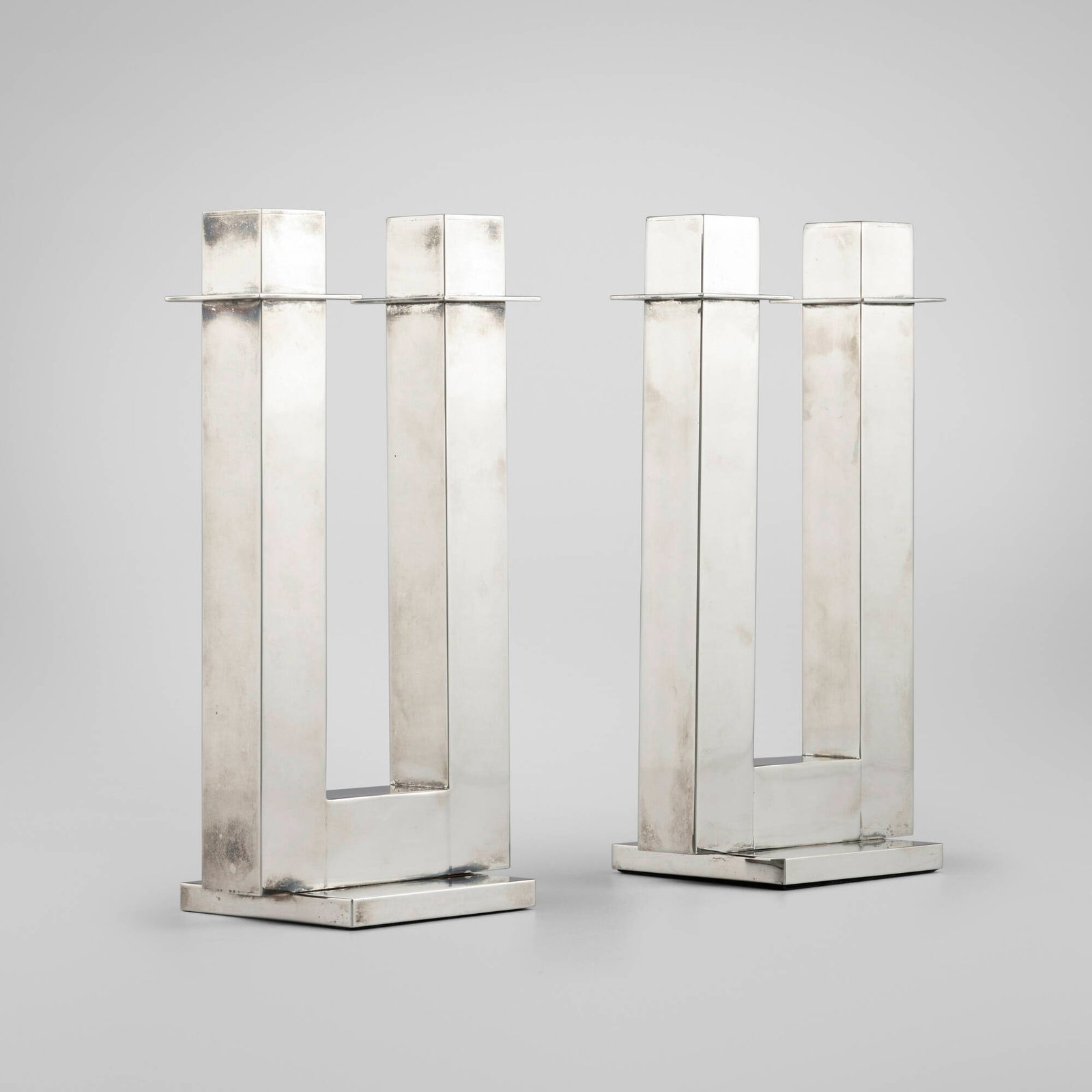 Richard Meier, Candelabra, pair: Richard Meier Candelabra, pair Swid Powell USA silver-plated metal 9.875 h x 5.5 w x 3.625 d in (25 x 14 x 9 cm) Impressed manufacturer's mark to underside of each example 'NAN SWID Design