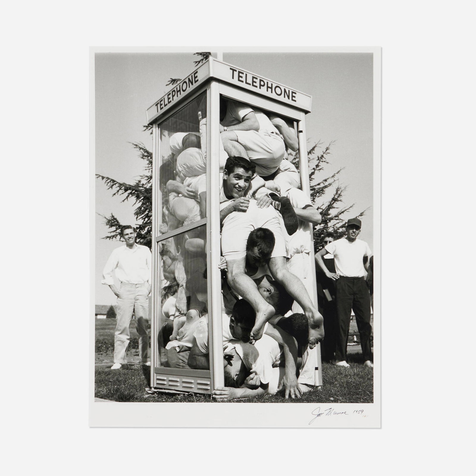 Joe Munroe, Telephone Booth Stuffing Contest: Joe Munroe Telephone Booth Stuffing Contest 1959 gelatin silver print image: 16.25 h x 13 w in (41 x 33 cm) sheet: 19.75 h x 19 w in (50 x 48 cm) Signed and dated to lower right margin 'Joe