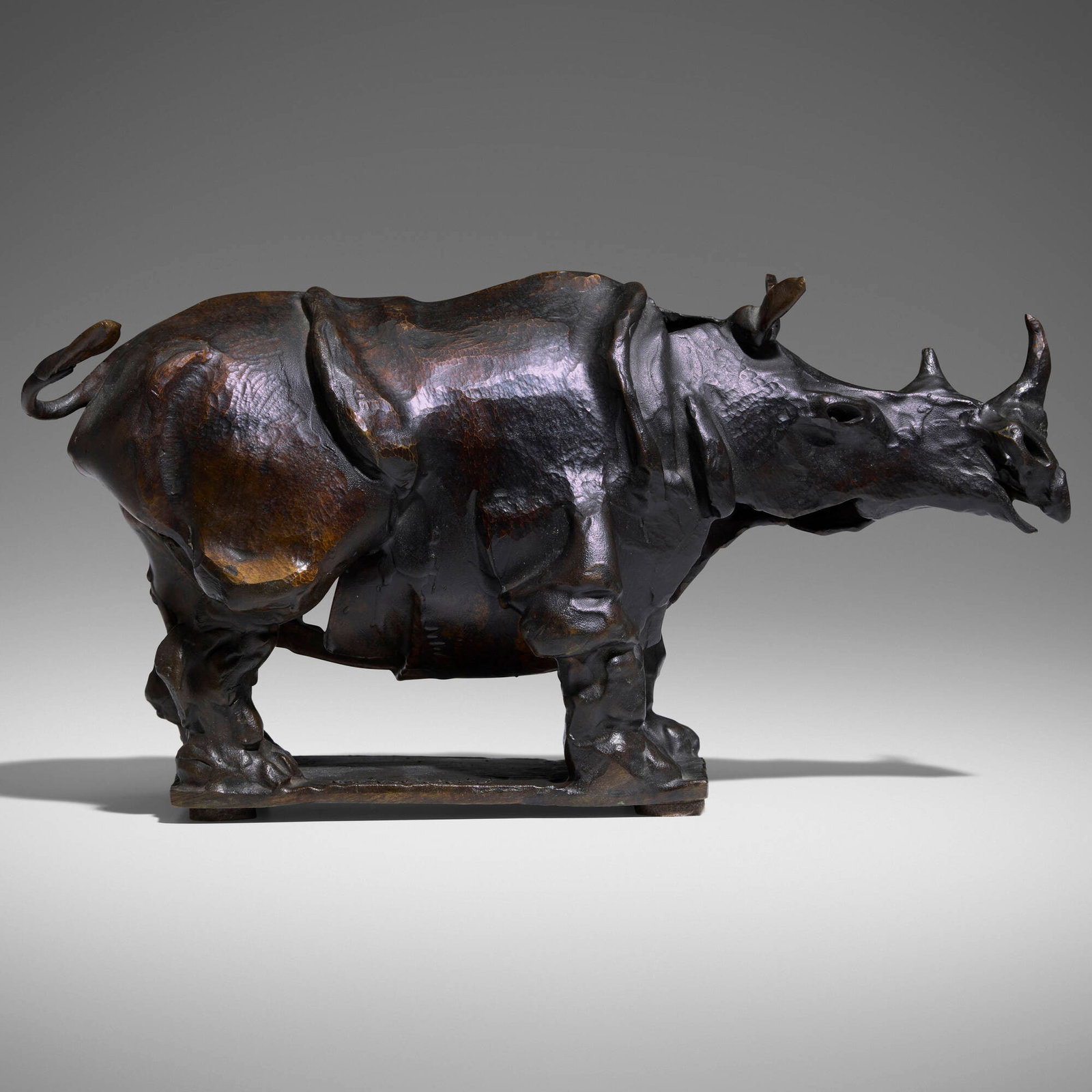 John Kearney, Rhino: John Kearney Rhino patinated bronze 6.25 h x 4.5 w x 12 d in (16 x 11 x 30 cm) Cast signature to base 'Kearney'. Incised inscription to underside '0-55'. Provenance: Acquired d