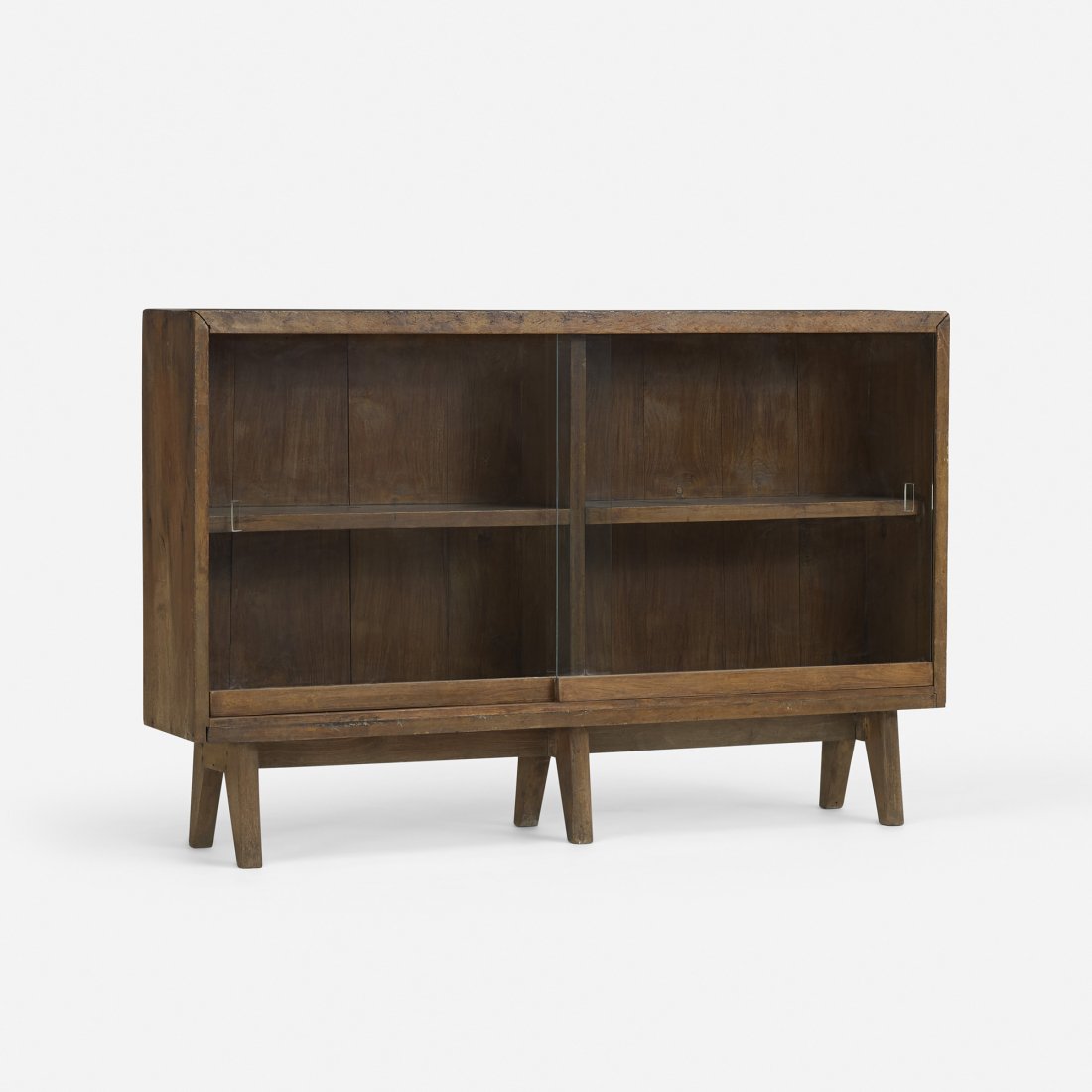 Jeanneret bookcase from Chandigarh: Pierre Jeanneret bookcase from the College of Fine Art, Chandigarh France/India, c. 1960 teak, glass 54 w x 10.25 d x 35 h inches Literature: Le Corbusier Pierre Jeanneret: The Indian Adventure, Desig