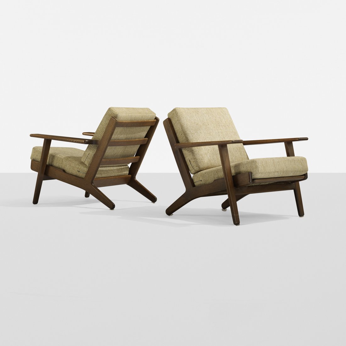 Hans Wegner lounge chairs model GE290, pair: Hans Wegner lounge chairs model GE290, pair Getama Denmark, c. 1960 stained oak, upholstery 29.75 w x 32 d x 28 h inches Signed with branded manufacturer's mark to underside of each example: [Getama G