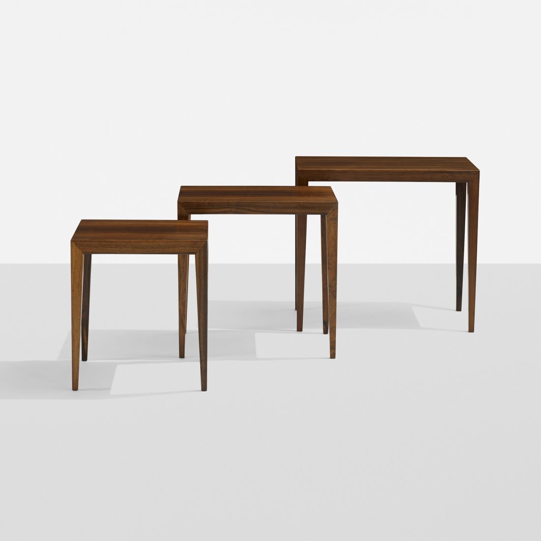 Ole Wanscher nesting tables, set of three: Ole Wanscher nesting tables, set of three Haslev Mobelsnedkeri A/S Denmark, c. 1965 rosewood 22.5 w x 14.5 d x 20.5 h inches Signed with manufacturer's logo to underside of each example with Danish co