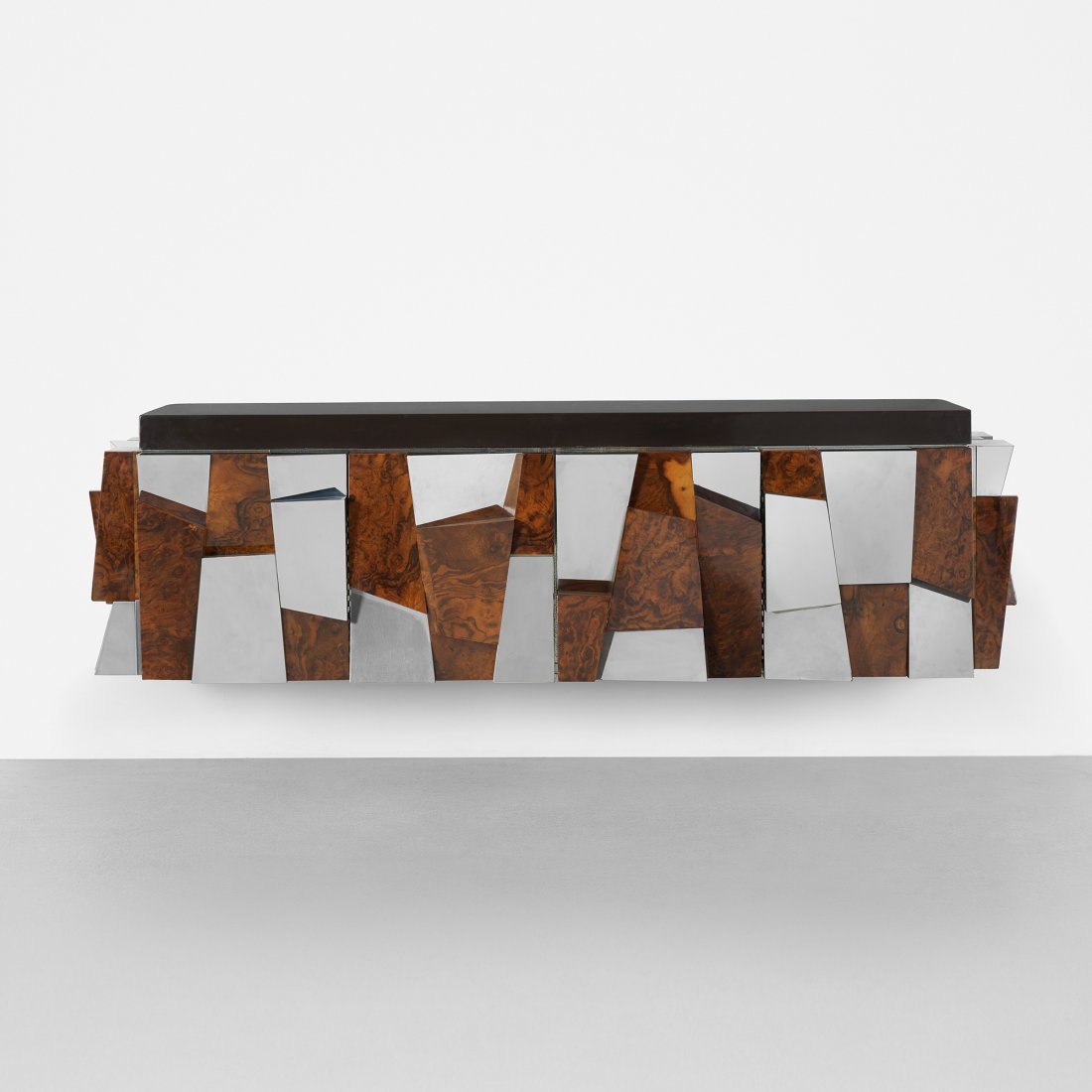 Paul Evans wall-mounted faceted cabinet: Paul Evans wall-mounted faceted cabinet Paul Evans Studio for Directional USA, c. 1975 chrome-plated steel, walnut burl, lacquered fiberglass 81 w x 24 d x 23 h inches Cabinet features two bi-fold doo