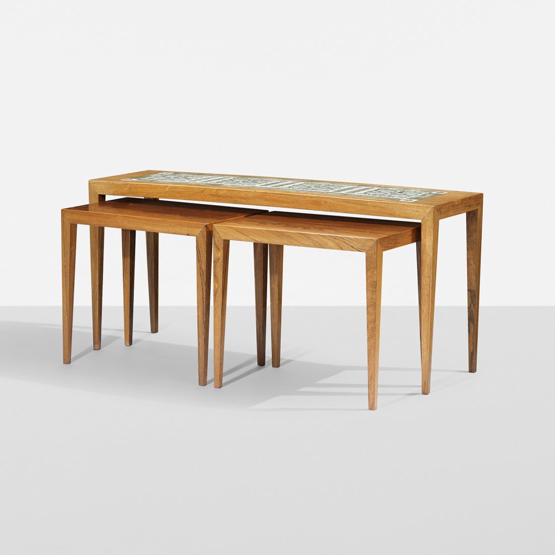 Hansen Jr. and Thorsson Nesting tables, three: Severin Hansen Jr. and Nils Thorsson Nesting tables, set of three Haslev Mobelsnedkeri A/S Denmark, c. 1960 rosewood, glazed ceramic 43.25 w x 12.5 d x 19.75 h inches Smaller tables measure: 19.25 w x