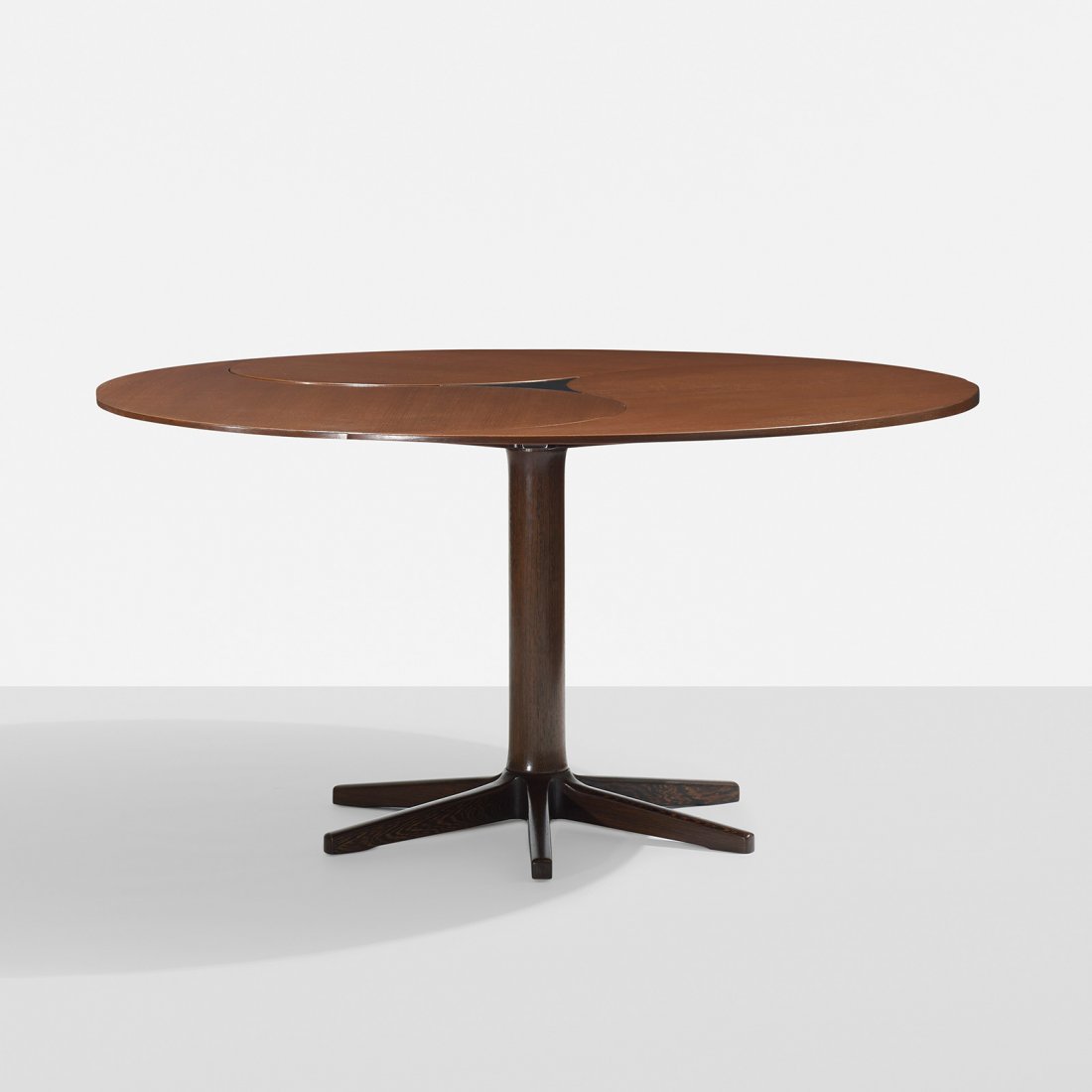 Ole Gjerlov-Knudsen and Torben Lind dining table: Ole Gjerlov-Knudsen and Torben Lind dining table France and Sons Denmark, 1963 mahogany, stained oak, laminate 53 dia x 27.5 h inches Table features pinwheel leaf mechanism with one removable petal-sh