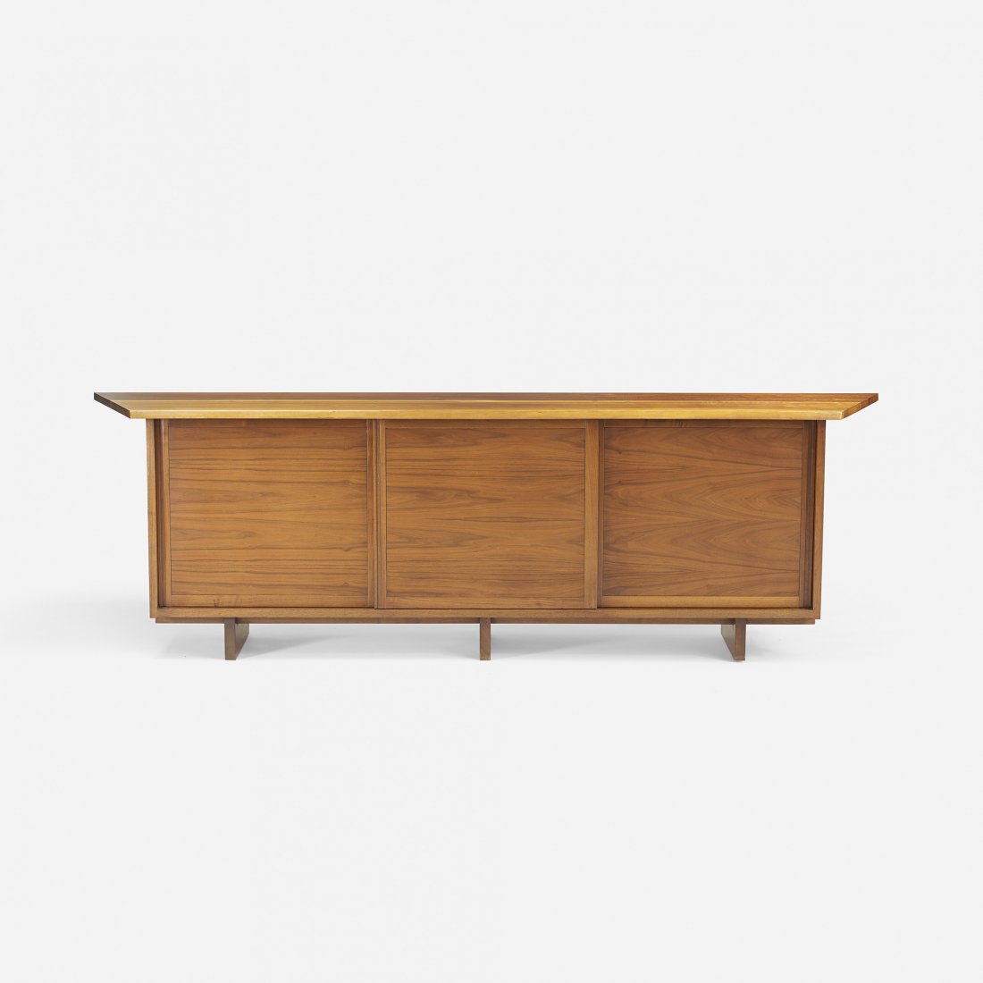 George Nakashima Special Triple cabinet: George Nakashima Special Triple cabinet USA, 1957 American black walnut 104 w x 21.75 d x 32.25 h inches Joined top with overhanging free edge and sap grain details. Cabinet features three doors conce