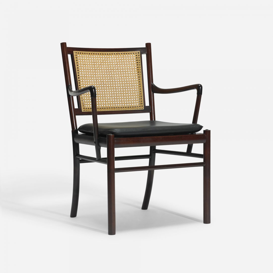 Ole Wanscher armchair: Ole Wanscher armchair Poul Jeppesen Denmark, c. 1960 mahogany, leather, cane 23 w x 22.5 d x 33.5 h inches Signed with decal manufacturer's label to underside: [PJ Danmark P. Jeppesen MÃ¸belfabrik A