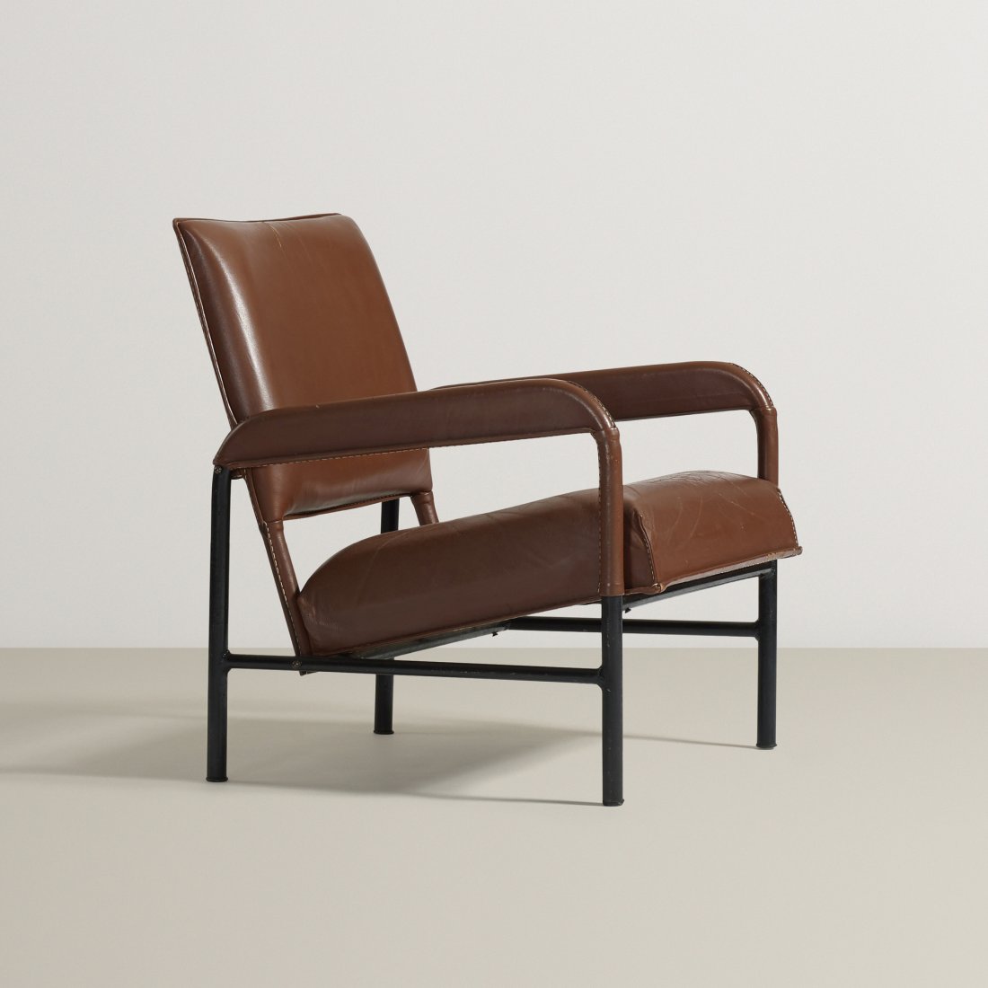 Jacques Adnet armchair from S.S. Île de France: Jacques Adnet armchair from S.S. Île de France France, c. 1950 saddle-stitched leather, enameled steel, brass 25 w x 28 d x 29.75 h inches Provenance: S.S. Île de France