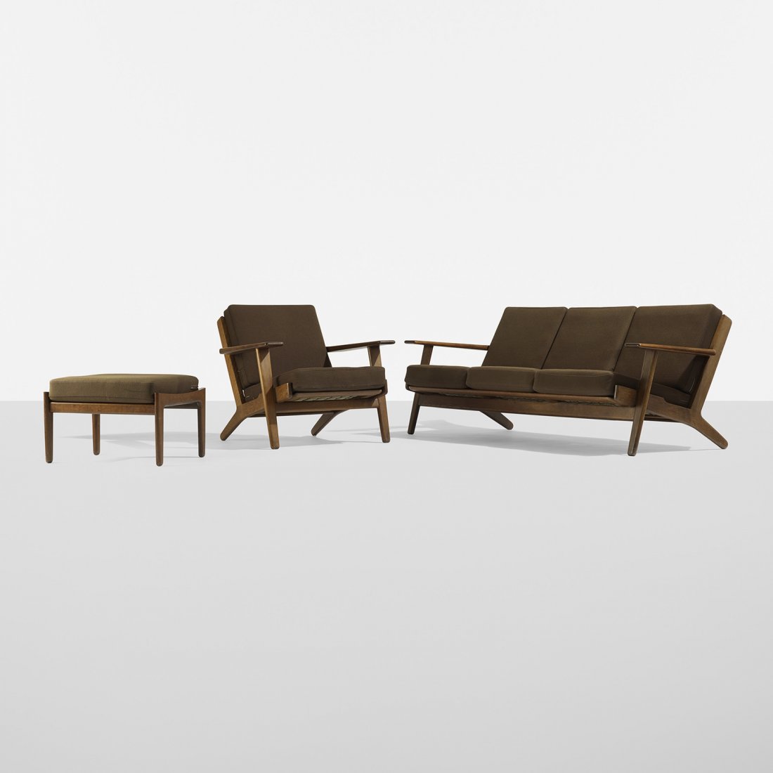 Hans Wegner suite of furniture: Hans Wegner suite of furniture Getama Denmark, 1953 stained oak, upholstery 71.25 w x 31 d x 27 h inches Suite includes sofa, model GE290/3, lounge chair, model GE290 and ottoman, model GE 290; lounge