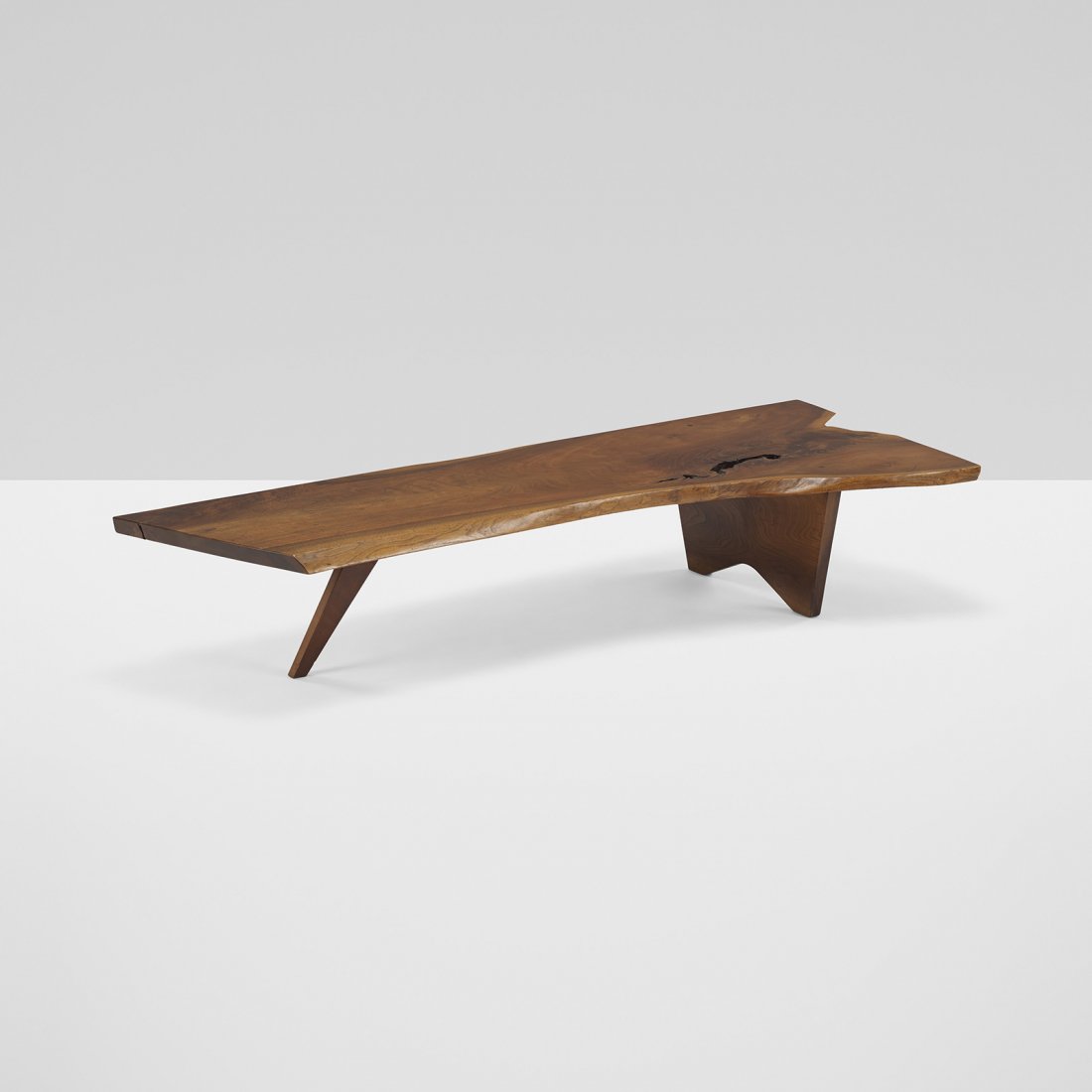 George Nakashima Slab coffee table: George Nakashima Slab coffee table USA, 1959 English walnut 71 w x 30.5 d x 13 h inches Table features solid board top with expressive grain, large open knot, and sap-grain details. Sold with a copy o