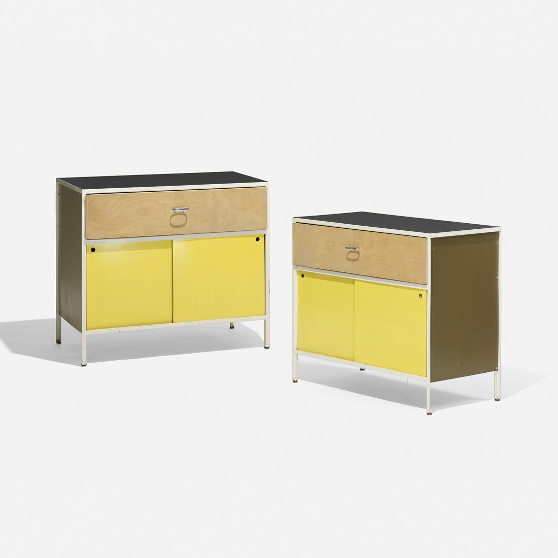George Nelson & Associates Steelframe cabinets, pair: George Nelson & Associates Steelframe cabinets, pair Herman Miller USA, 1950 lacquered masonite, enameled steel, birch, laminate, aluminum 33.5 w x 18.5 d x 29.5 h inches Each cabinet features one dra