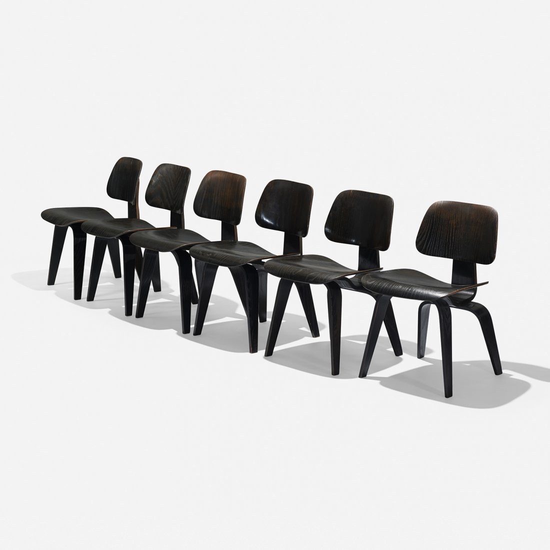 Charles and Ray Eames DCWs, set of six: Charles and Ray Eames DCWs, set of six Evans Products/Herman Miller USA, 1945/1948 aniline-dyed ash plywood, rubber 29 h x 19.25 w inches Signed with decal manufacturer’s label to underside four exa