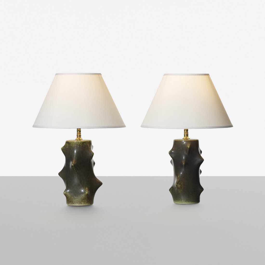 Knud Basse table lamps, pair: Knud Basse table lamps, pair Michael Andersen & Son Denmark, c. 1955 glazed stoneware, paper, brass 9.75 dia x 14.5 h inches Signed with studio cipher to underside.