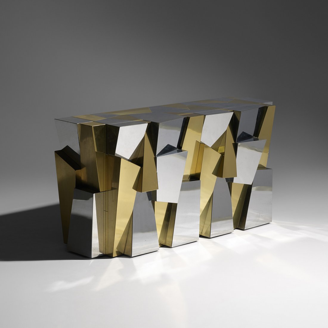 Paul Evans custom Faceted console: Paul Evans custom Faceted console Paul Evans Studio for Directional USA, c. 1965 chrome-plated steel, brass 51 w x 17.75 d x 26.5 h inches This custom console was ordered by the Steinfeld's through th