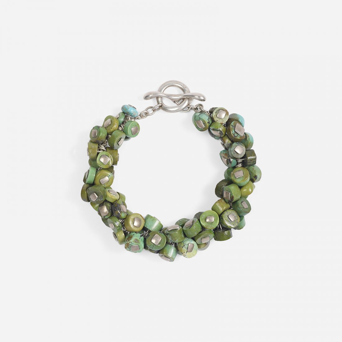 Robert Lee Morris a silver and turquoise bracelet: Robert Lee Morris a silver and turquoise bracelet A silver bracelet with clusters of turquoise attached to the central chain by handmade silver rivets. Signed '925 RLM'. Bracelet measures 10 inches in