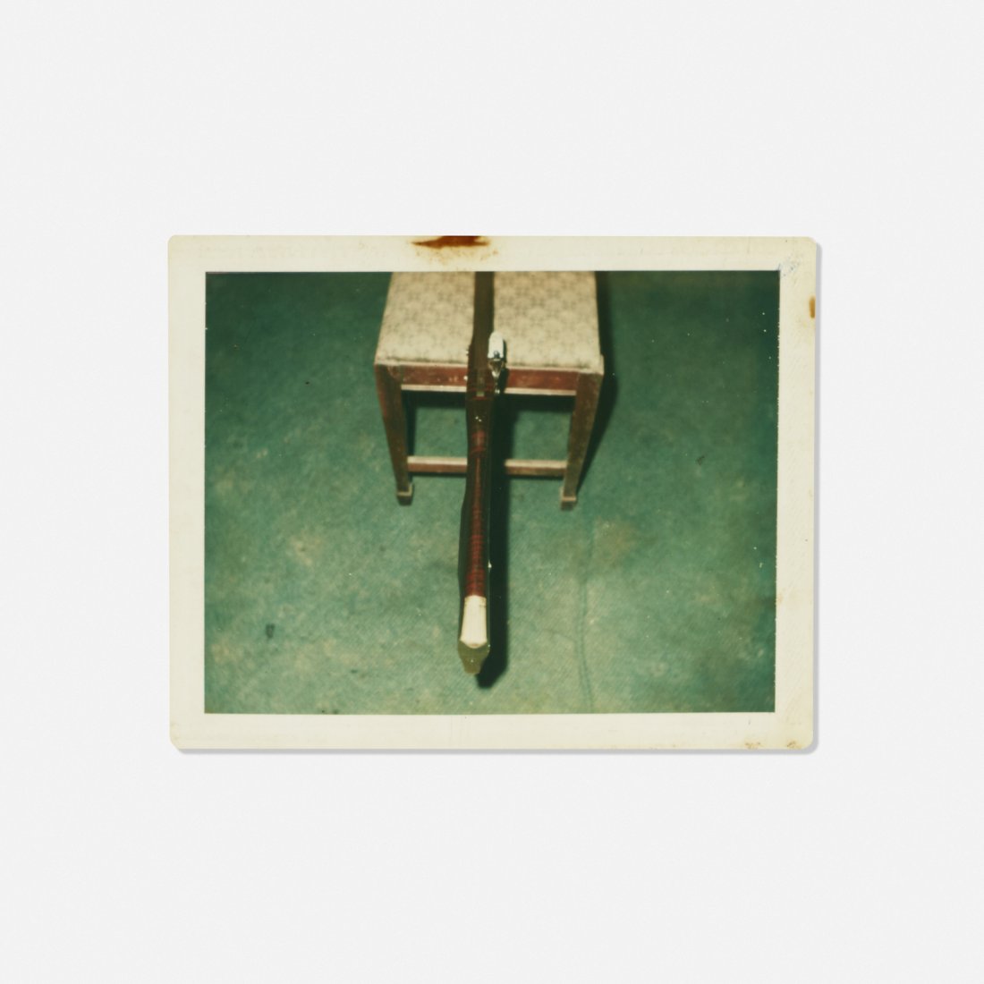 Andy Warhol, Untitled (Rifle on a Chair): Andy Warhol Untitled (Rifle on a Chair) Polaroid Polacolor print2.75 h x 3.75 w in (7 x 10 cm) Sheet measures: 3.25 h x 4.25 w in Blind stamped to lower right 'Andy Warhol'. Stamped to verso 'The E