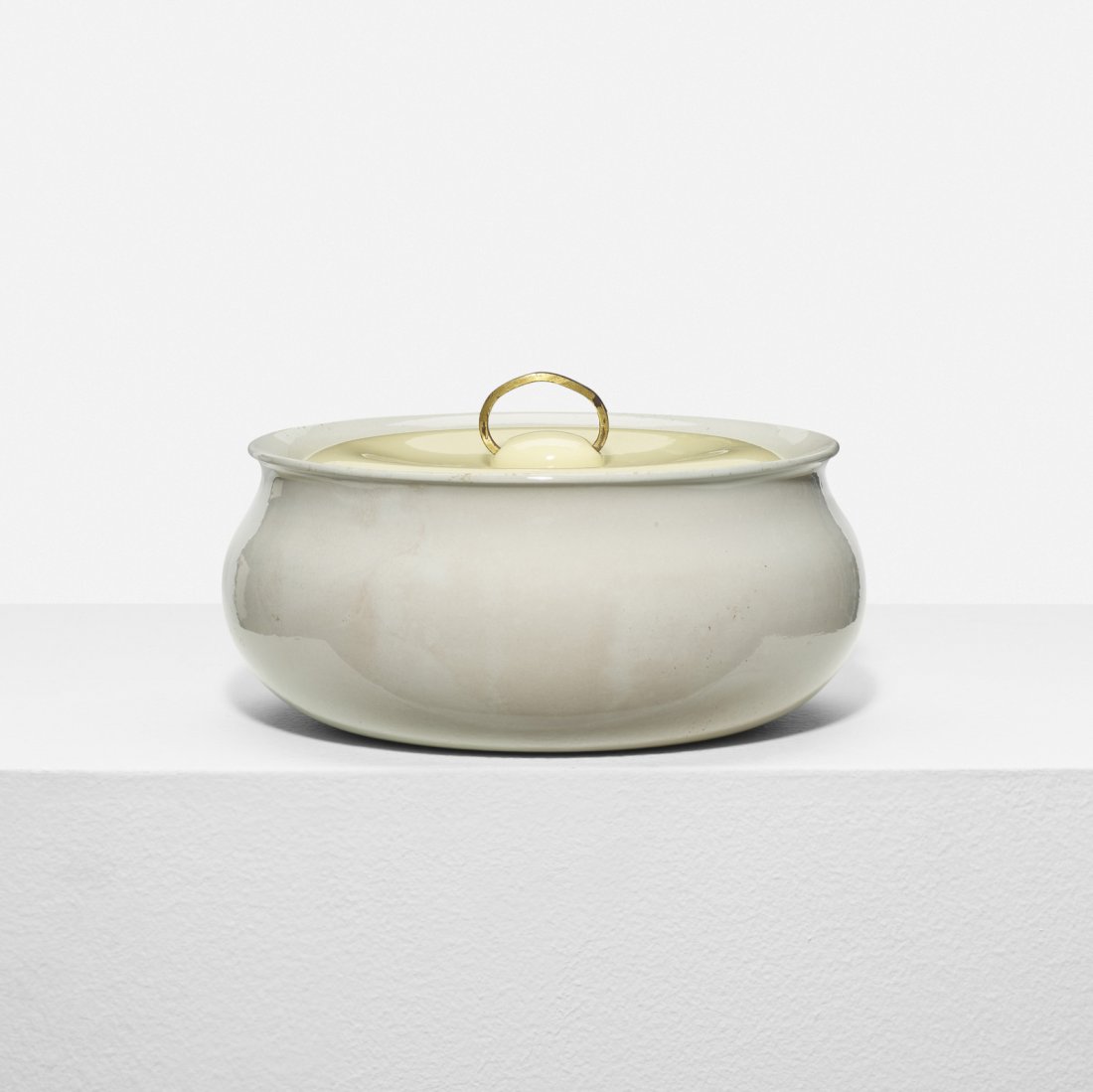 Eva Zeisel, lidded casserole dish: Eva Zeisel lidded casserole dish Riverside Ceramics CompanyHungary / USA, 1947glazed porcelain, brass9 dia x 5 h in (23 x 13 cm) Signed with stamped manufacturer's mark to underside: [Calif