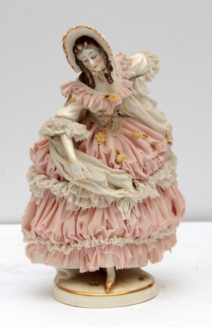 DRESDEN PORCELAIN FIGURE OF A LADY: Dresden porcelain figure of a lady in a pink dress. Some loss to the lace. Measures approx: 8 5/8" height.