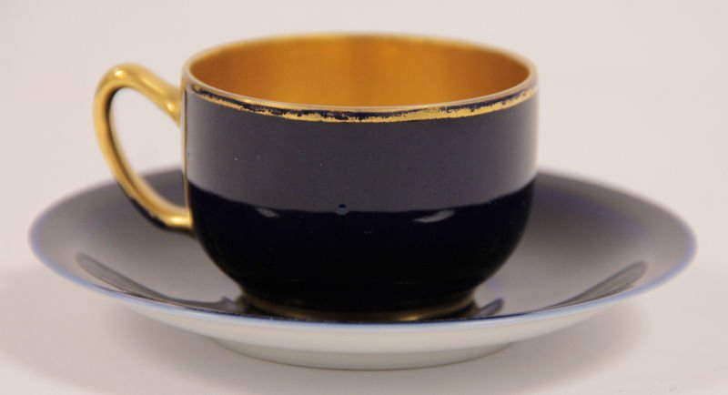 Rosenthal Porcelain Cup and Saucer: Rosenthal Porcelain, cobalt blue, "Demi Tasse" cup and saucer. The cup measures 1.25" in height and has gilt interior; the saucer is 1.5" in diameter.